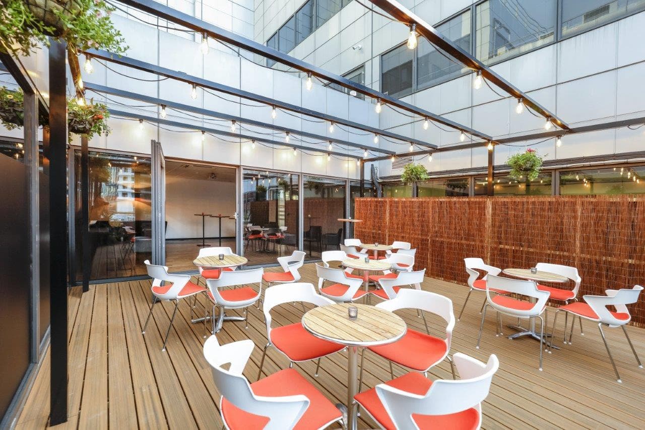Modern Juniper Room outdoor terrace with string lighting for networking and corporate events.