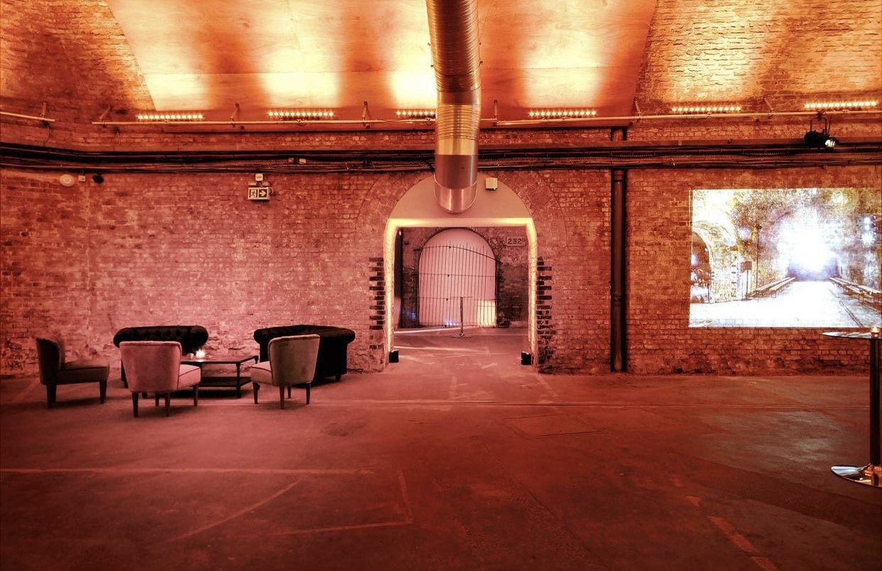 Versatile event space with exposed brick walls, ideal for corporate meetings and social gatherings.