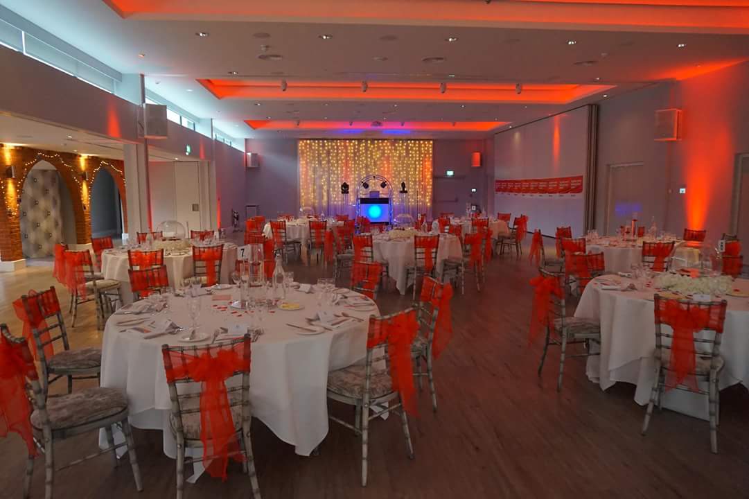 Garden Suite at Greenwoods Hotel: elegant event space with round tables and orange sashes.