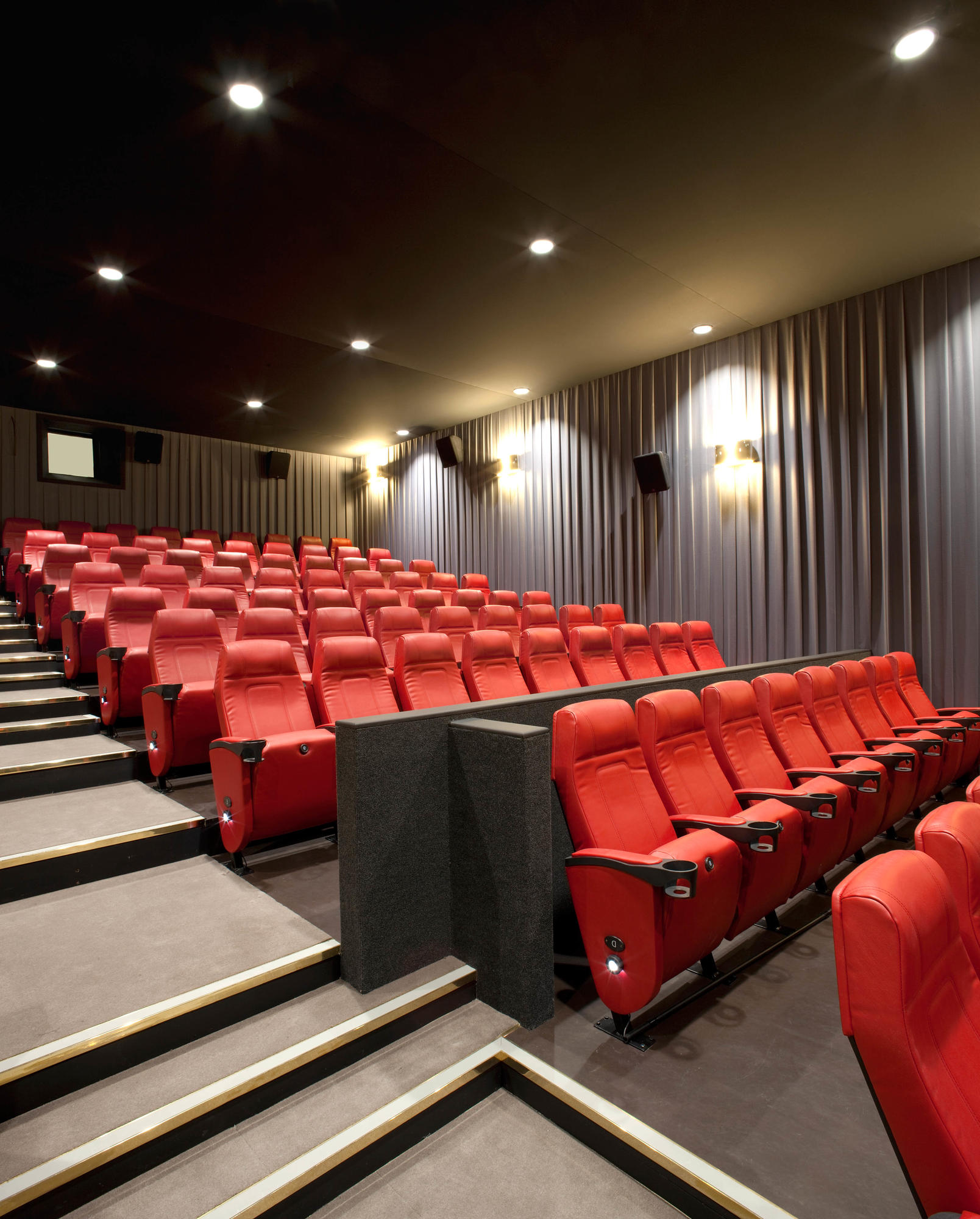 Modern auditorium with plush red seating at Barbican Centre for corporate events and screenings.
