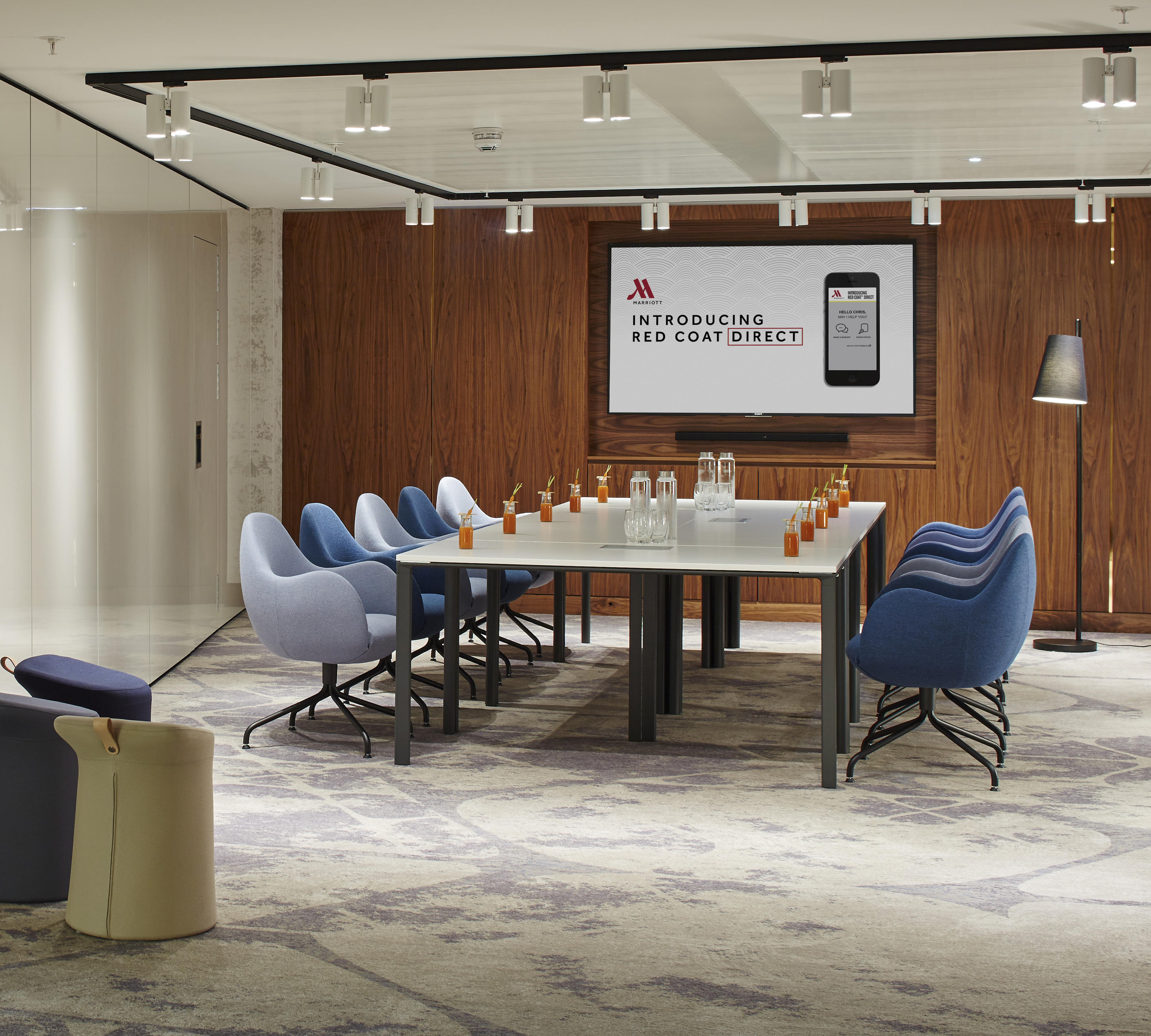 Modern meeting room at London Heathrow Marriott with digital display for events.