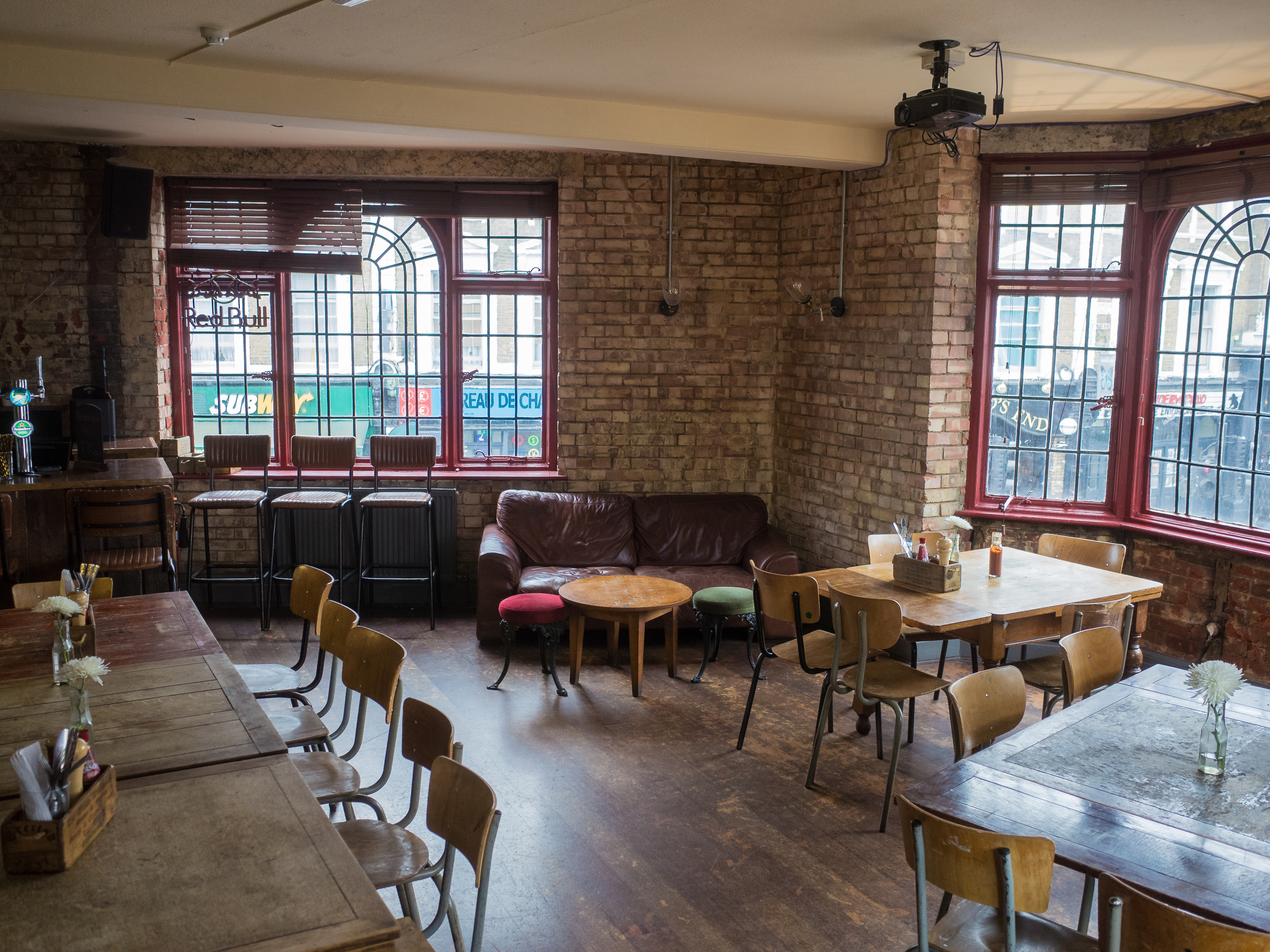 Cozy rustic function room with warm brick walls for intimate meetings and events.