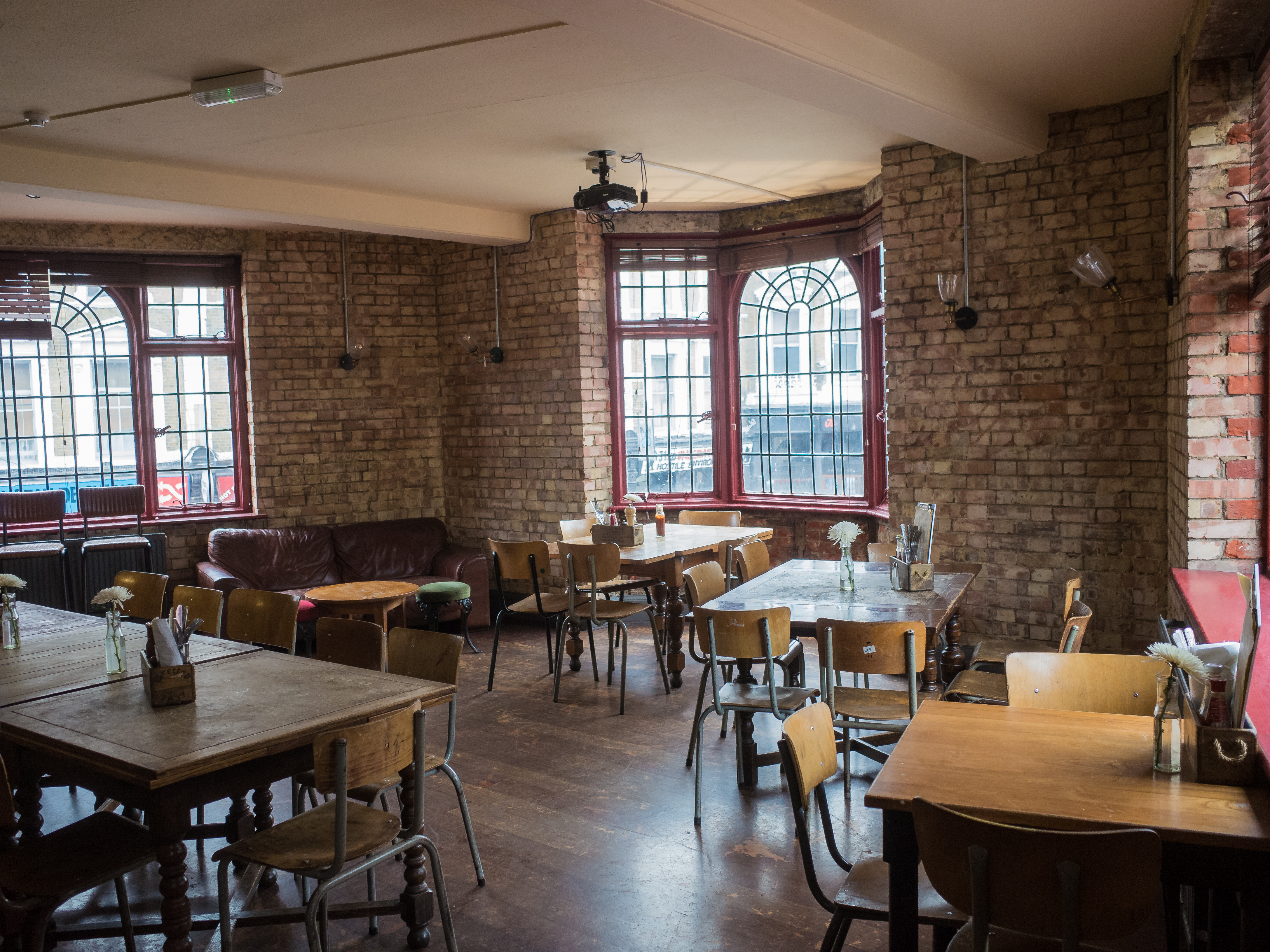 Versatile event space with exposed brick walls, ideal for meetings and networking.
