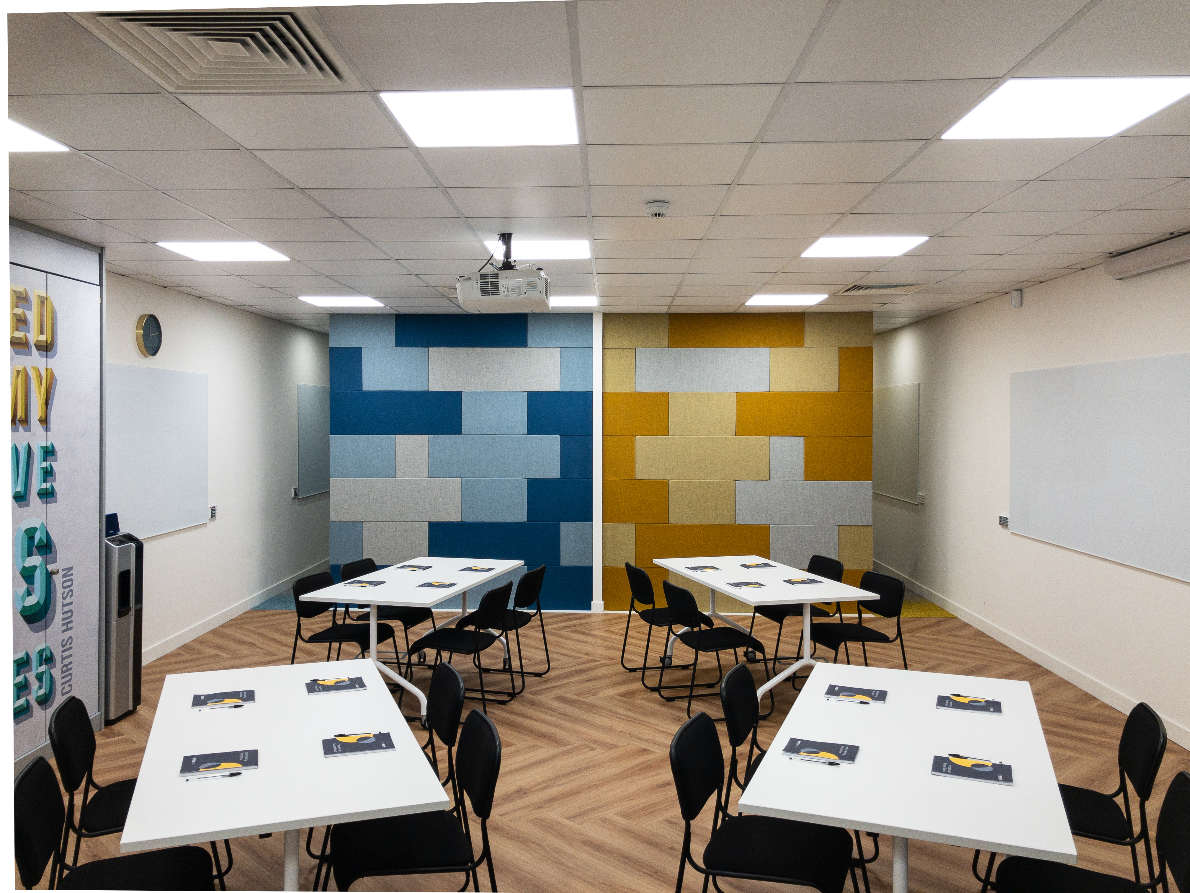 Collaborative workshop space with vibrant colors, ideal for meetings and brainstorming.