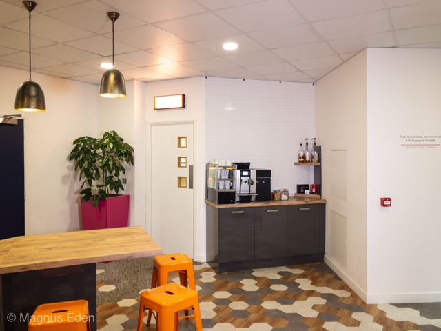 Modern workshop break area with coffee station for networking and events.