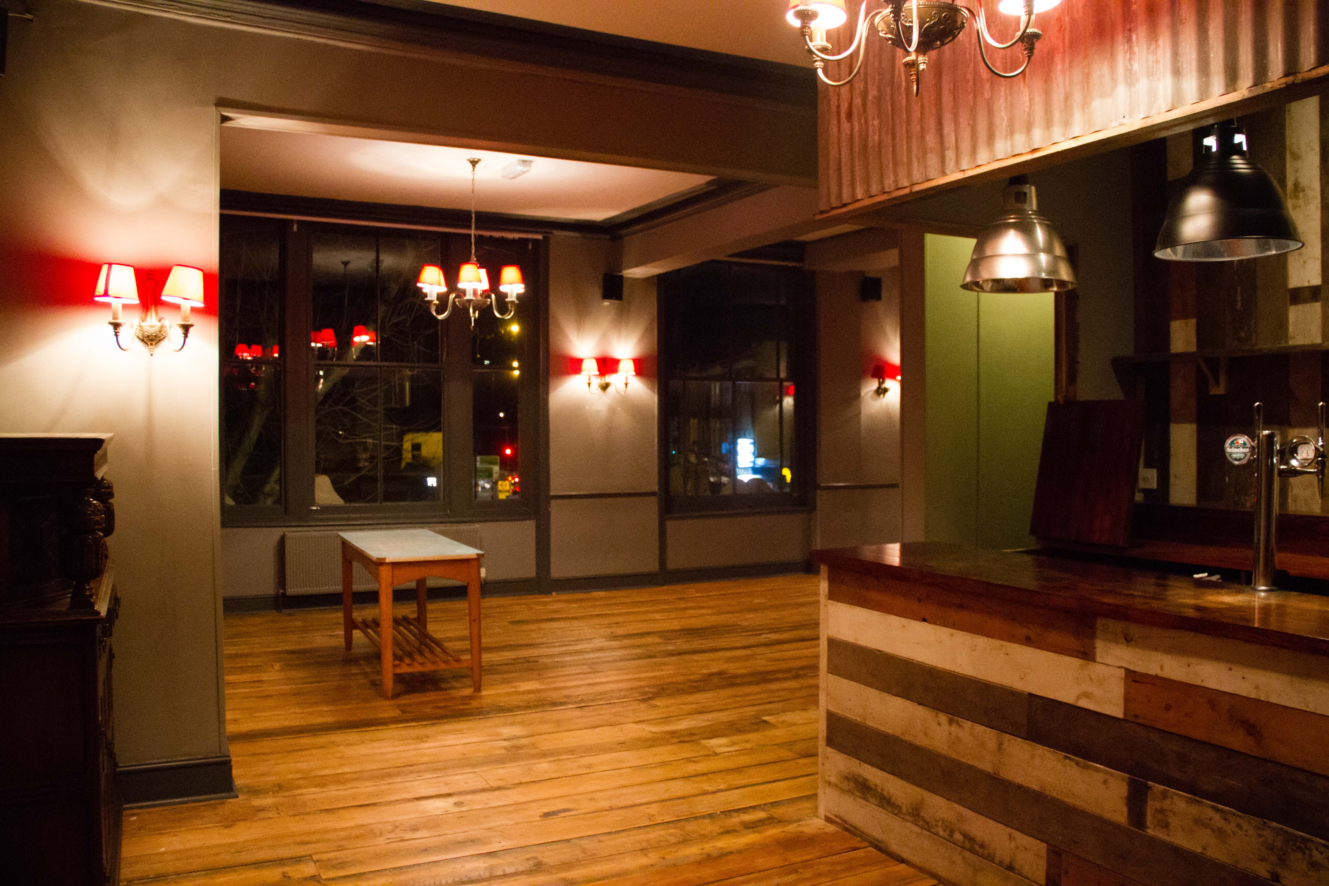 Versatile event space with warm lighting, ideal for networking and gatherings.