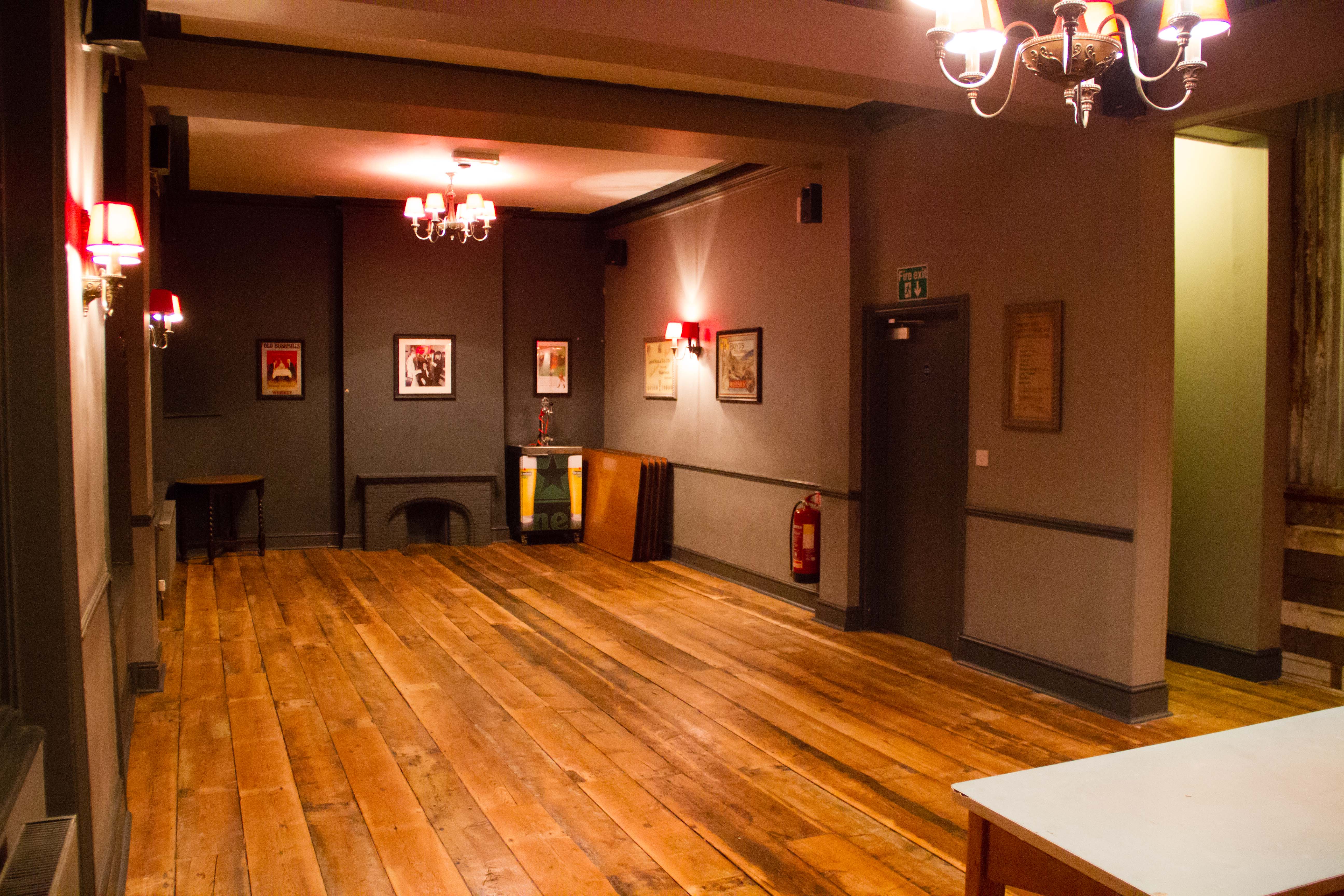 Versatile event space with warm lighting, ideal for gatherings and workshops.