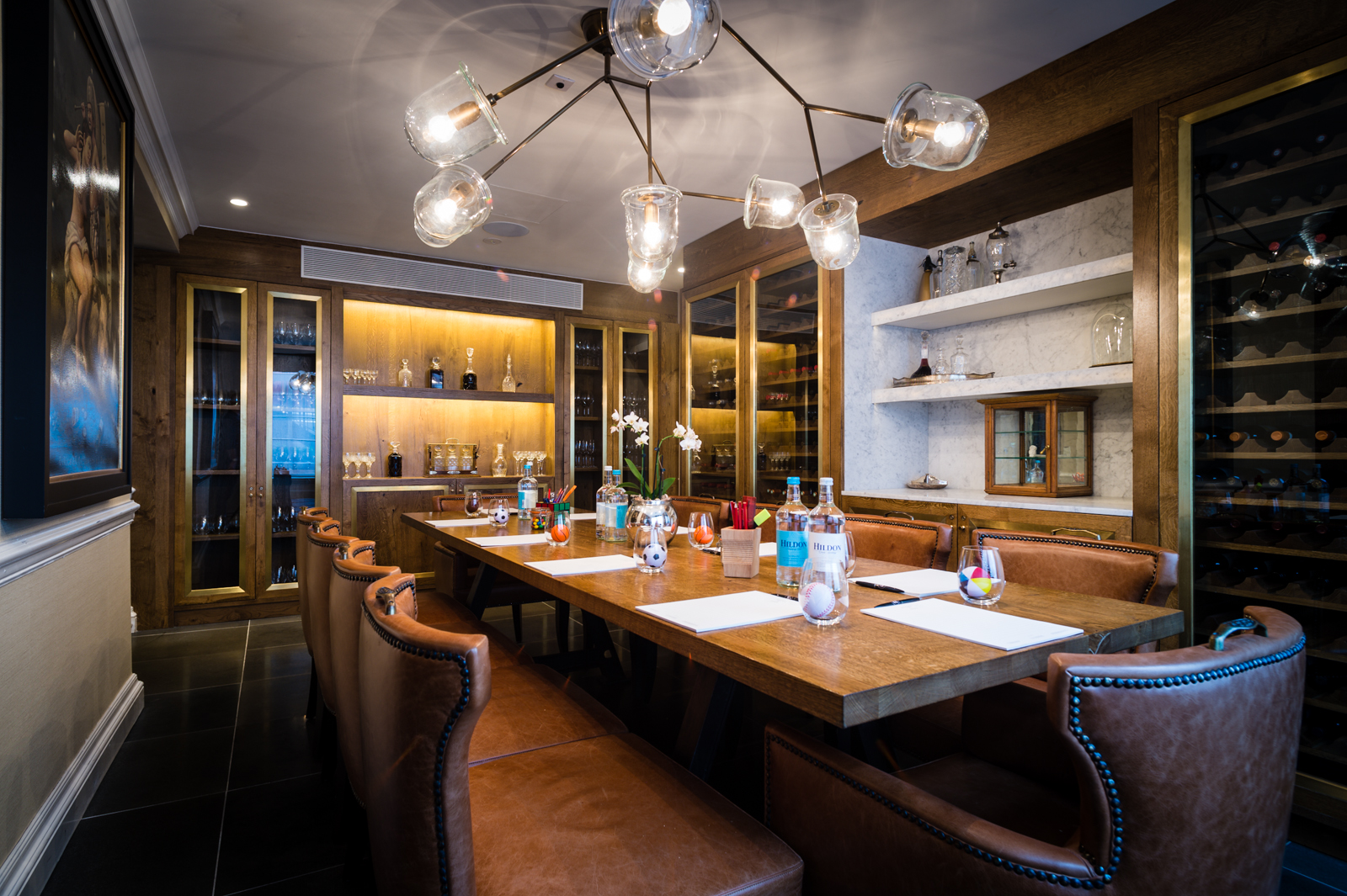 Elegant meeting room with wooden table and leather chairs for exclusive events.