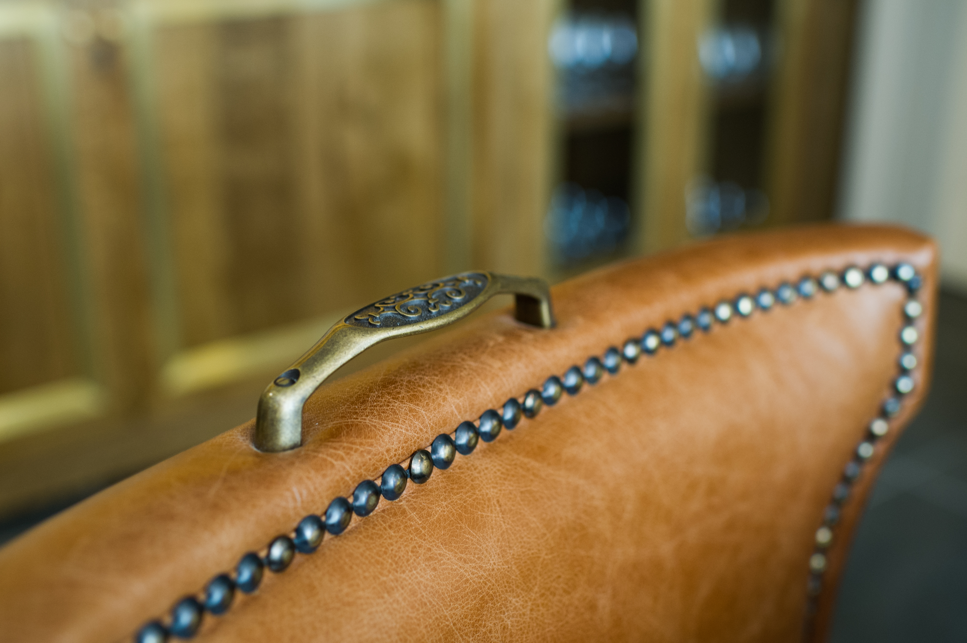Stylish leather chair with nailhead trim in The Wine Room, Ampersand Hotel event space.