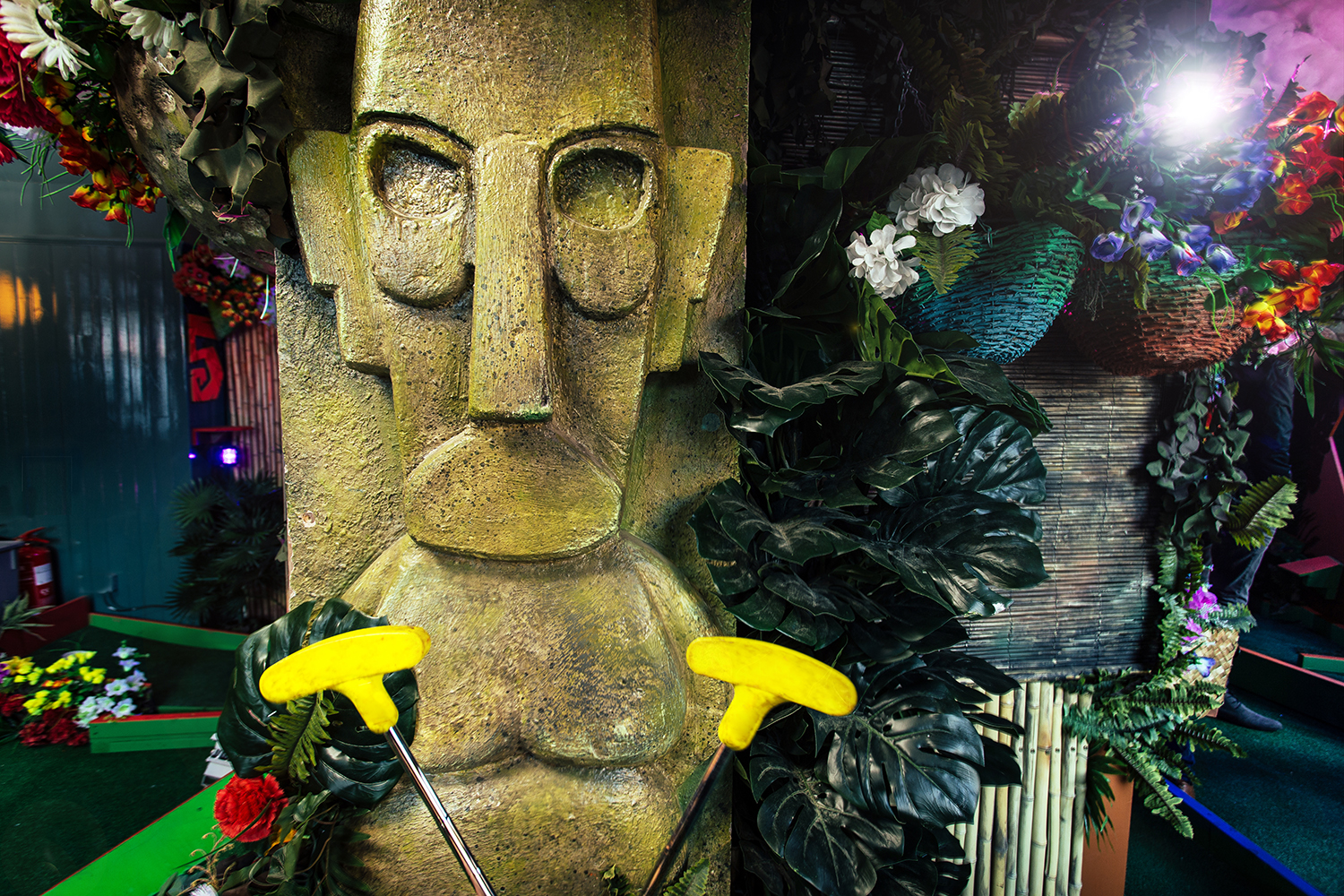 Easter Island statue at The Arcade, vibrant mini-golf for team-building events.