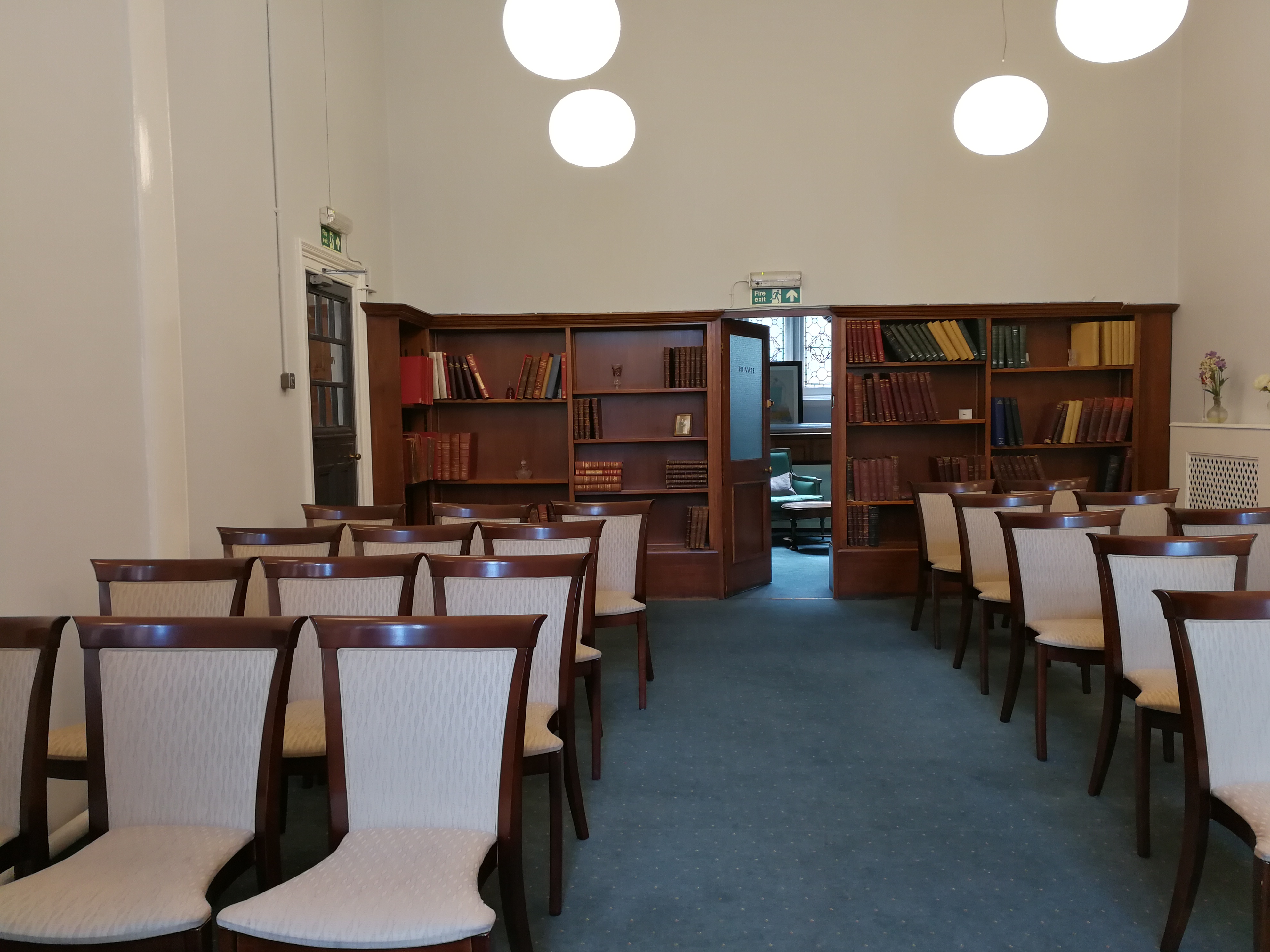 Cozy semi-circular meeting space in Mayfair Library, perfect for workshops and gatherings.