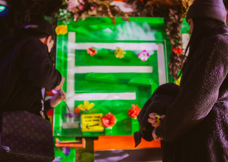 Colorful flower backdrop at Plonk Crazy Golf, Camden Market - interactive event setup.