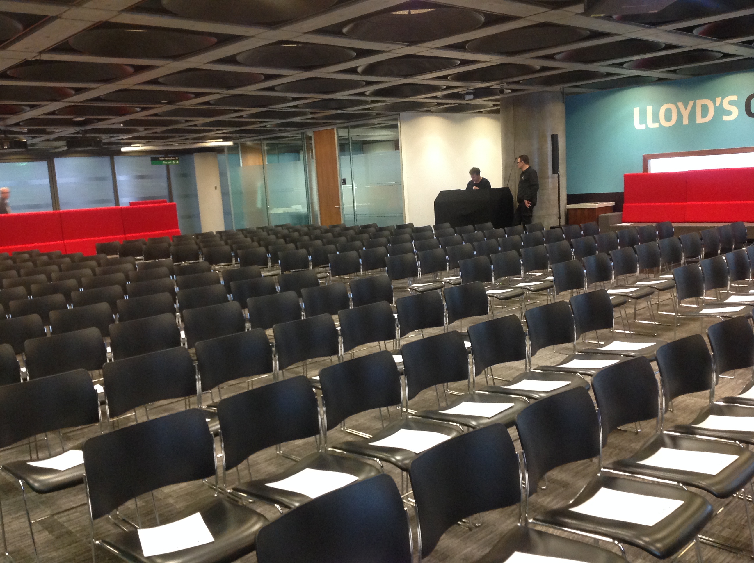 Banqueting Suite at Lloyd's, modern seminar venue with red accents and audience seating.