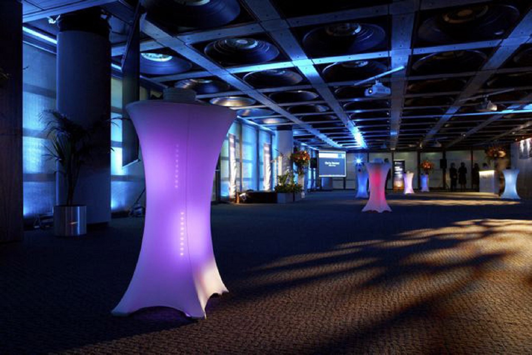 Stylish Lloyd's Banqueting Suite with illuminated cocktail tables for networking events.