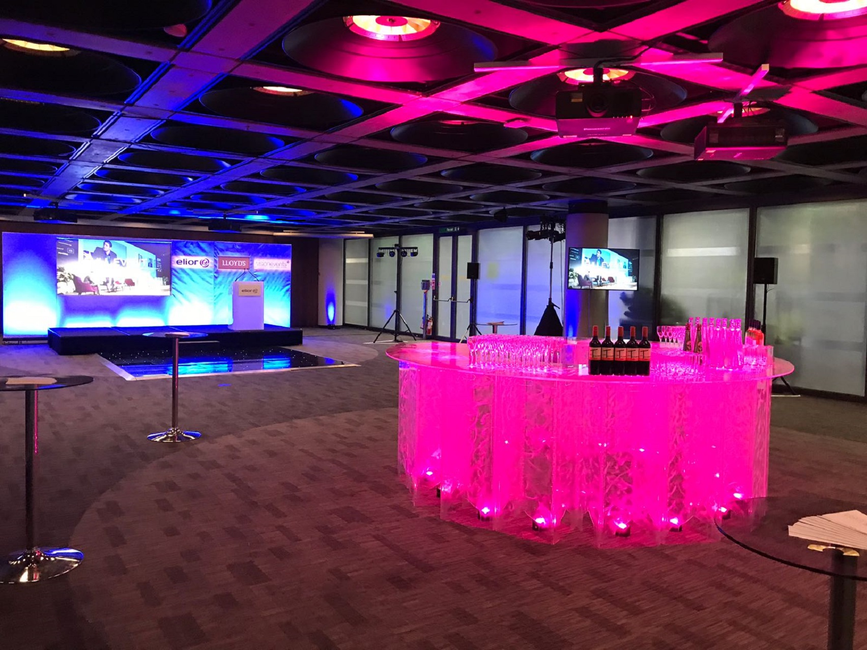 Elegant Banqueting Suite with illuminated bar, ideal for events and networking.