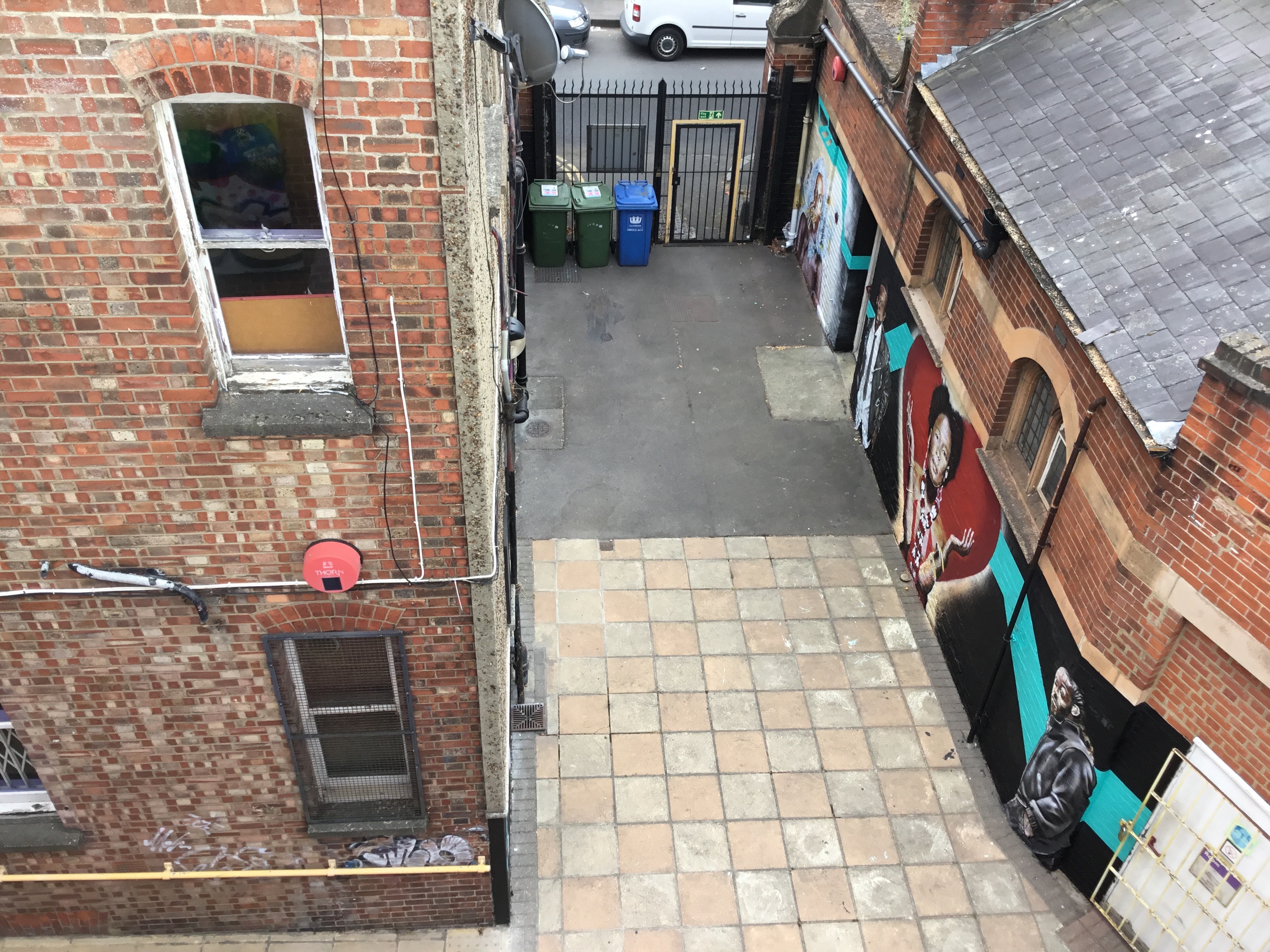 Rooftop event space with brick walls and vibrant street art for unique gatherings.