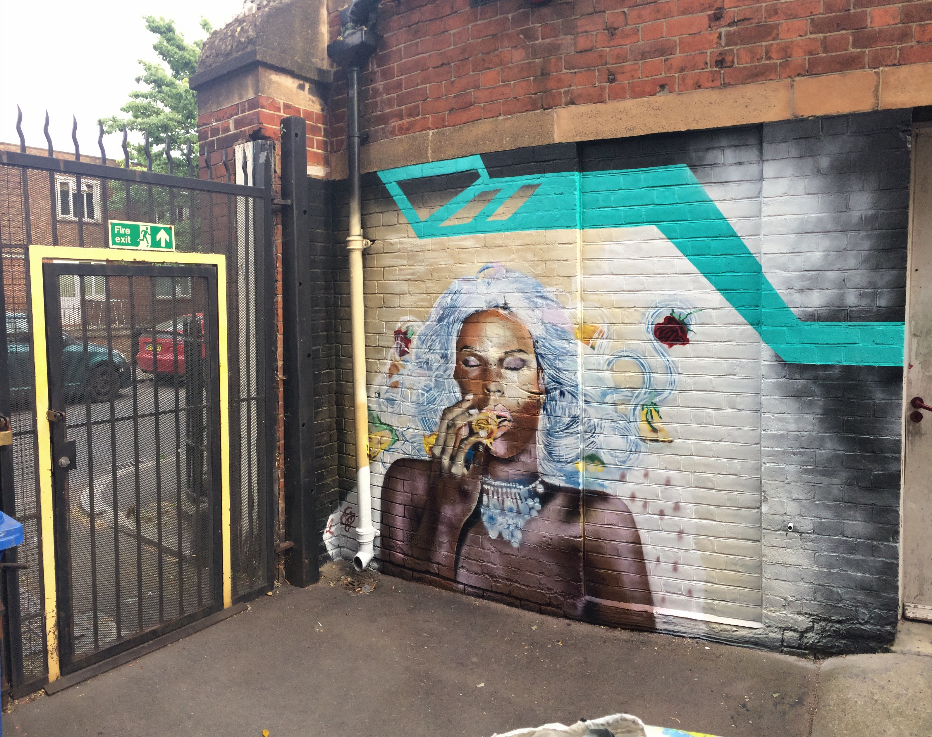 Vibrant mural of a woman in The Midi Music Company courtyard, ideal for events and branding.