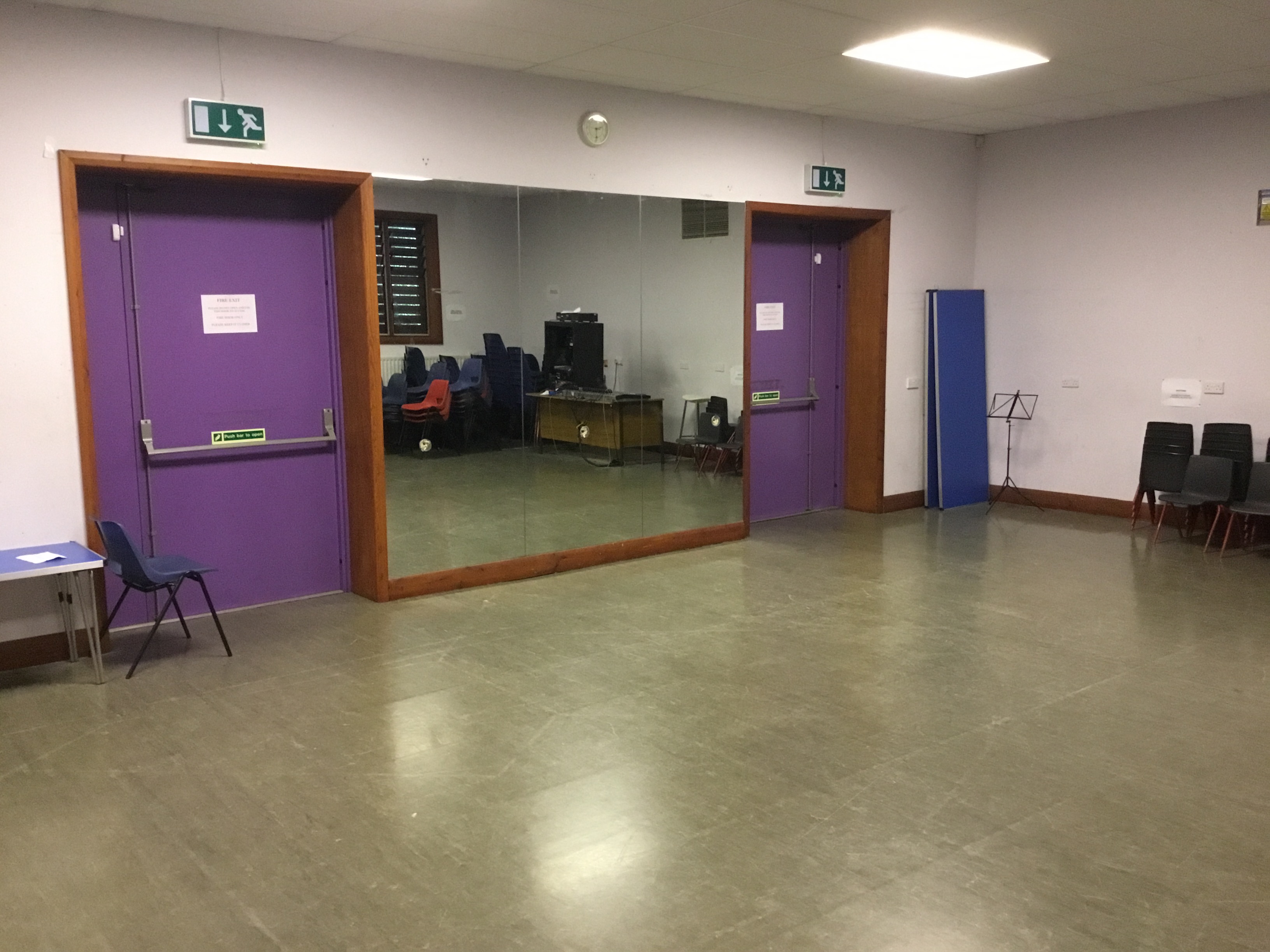 Versatile meeting space with large mirror for workshops and presentations at Midi Music Company.