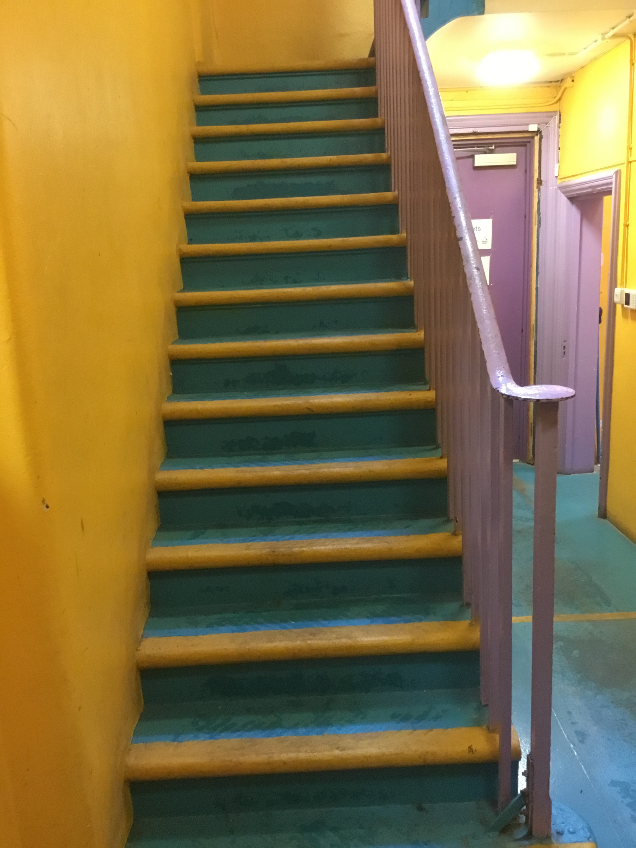 Brightly colored staircase at The Midi Music Company venue for events and gatherings.