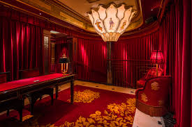 Elegant meeting space at Club Chinois with red drapery, ideal for high-end events.