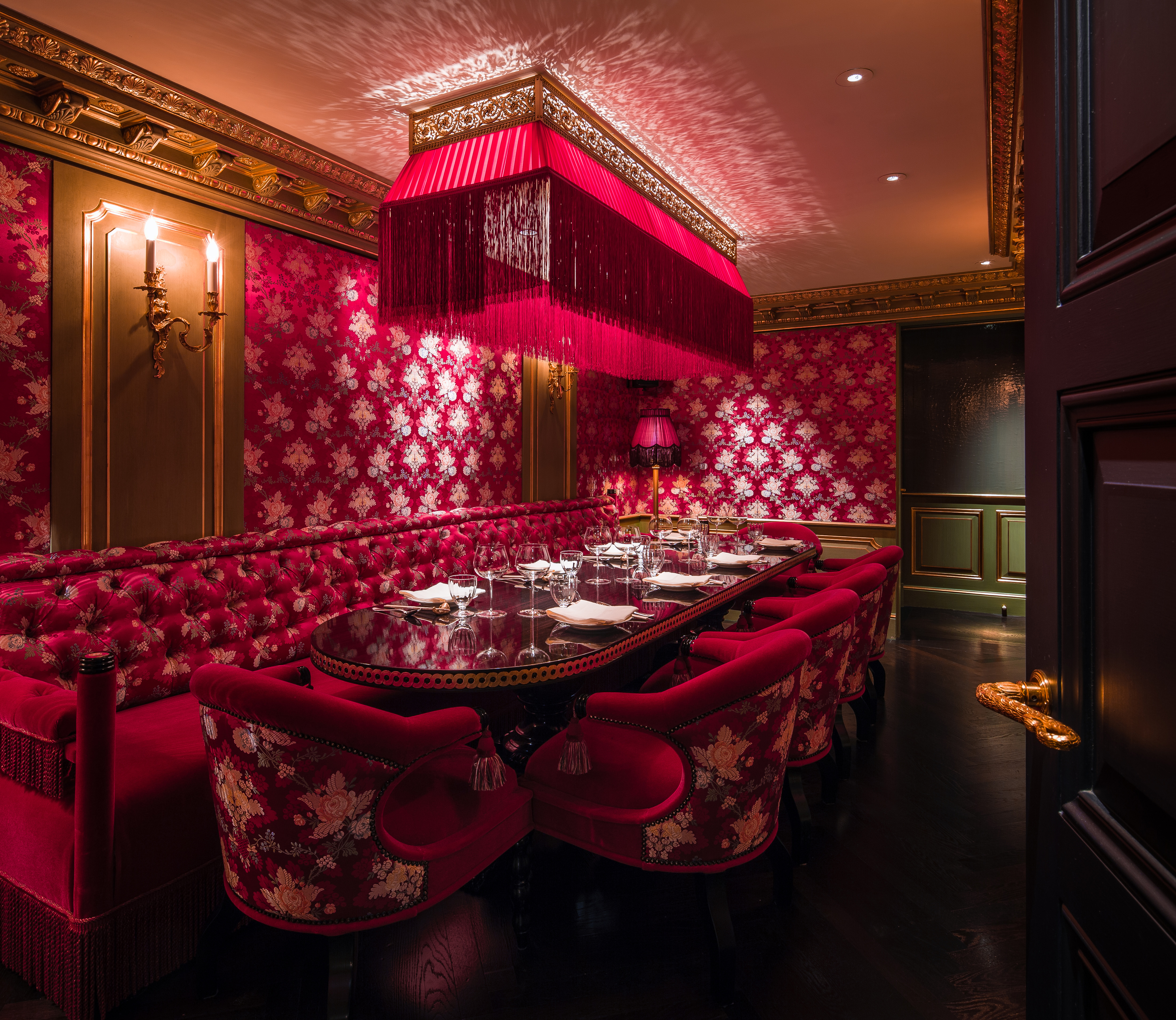 Opulent Salon Rouge dining space with rich red decor for exclusive events and intimate dinners.