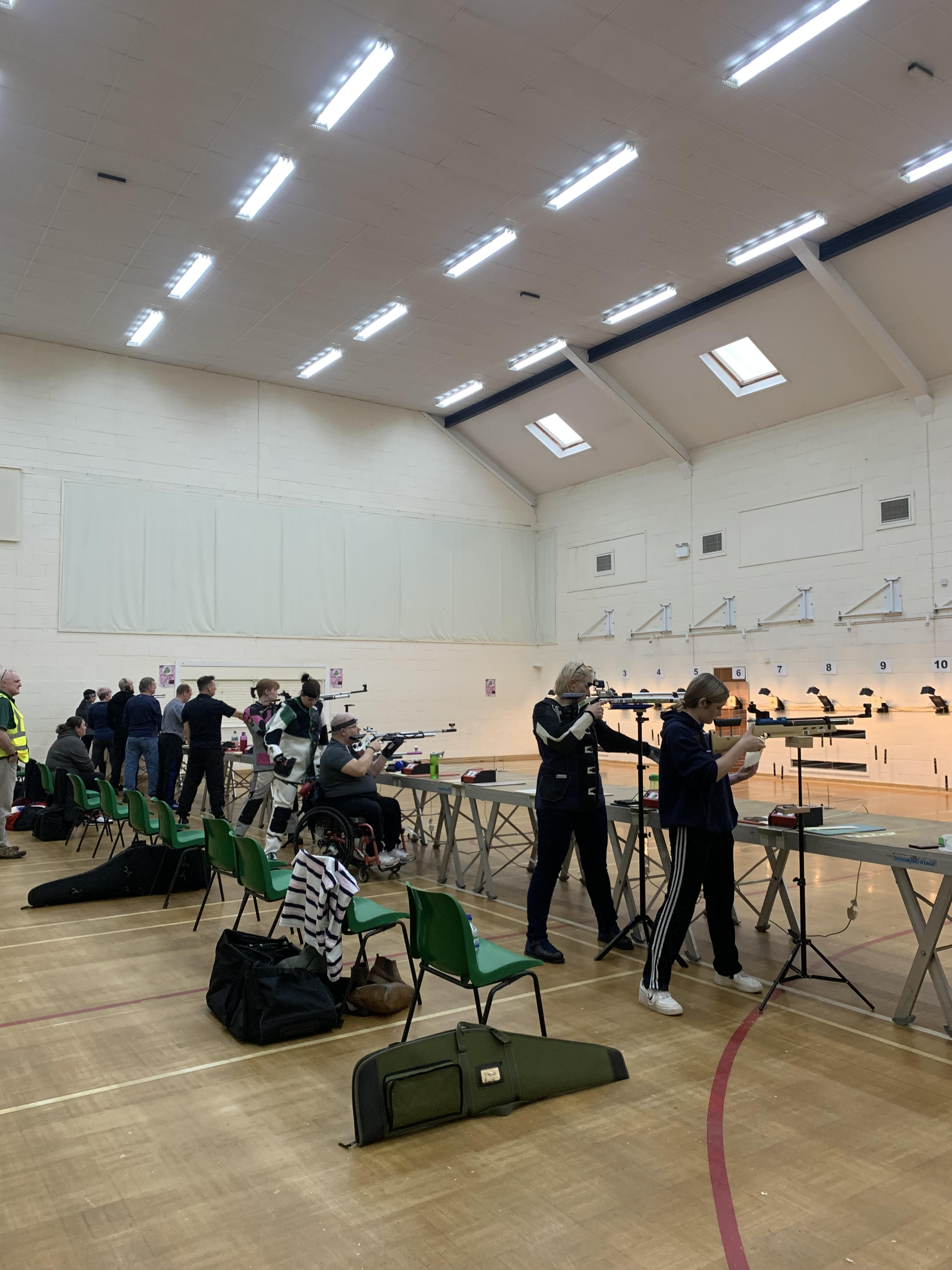 Shooting range event in Wickham Community Centre with organized lanes and safety focus.