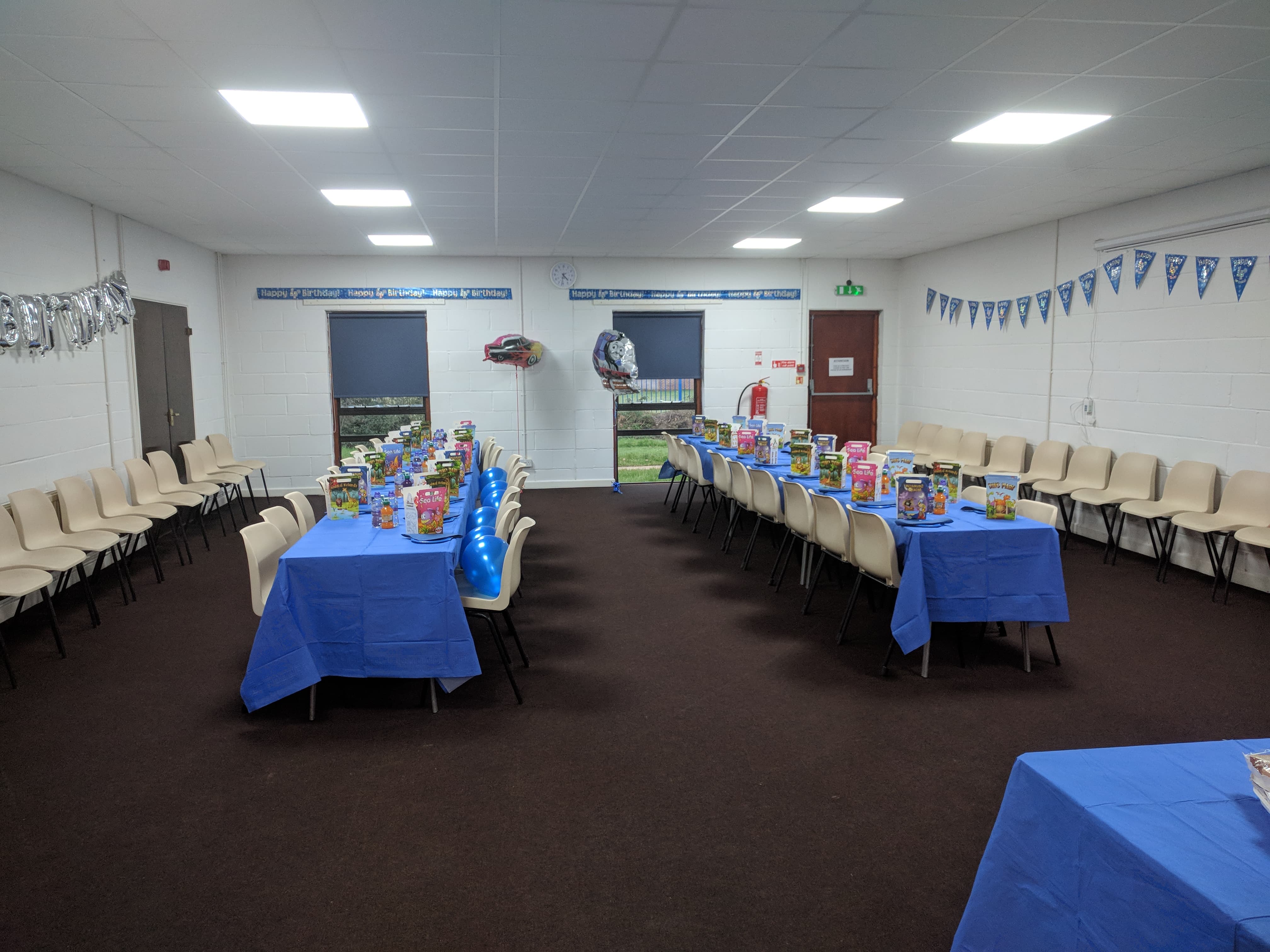 Houghton Room event space with blue tablecloths, perfect for gatherings and networking.