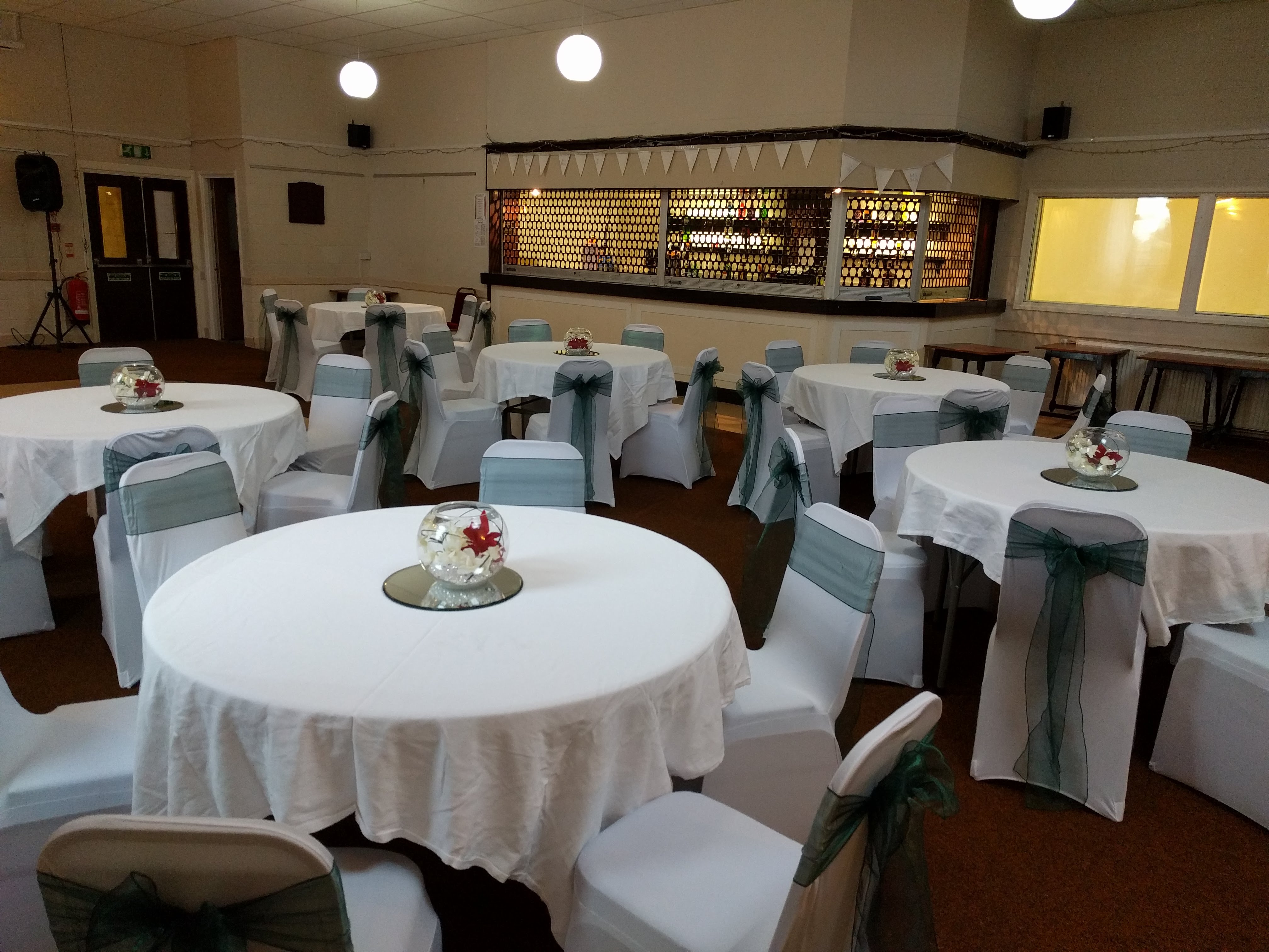 Elegant Woodford Suite event space with round tables, perfect for weddings and corporate events.