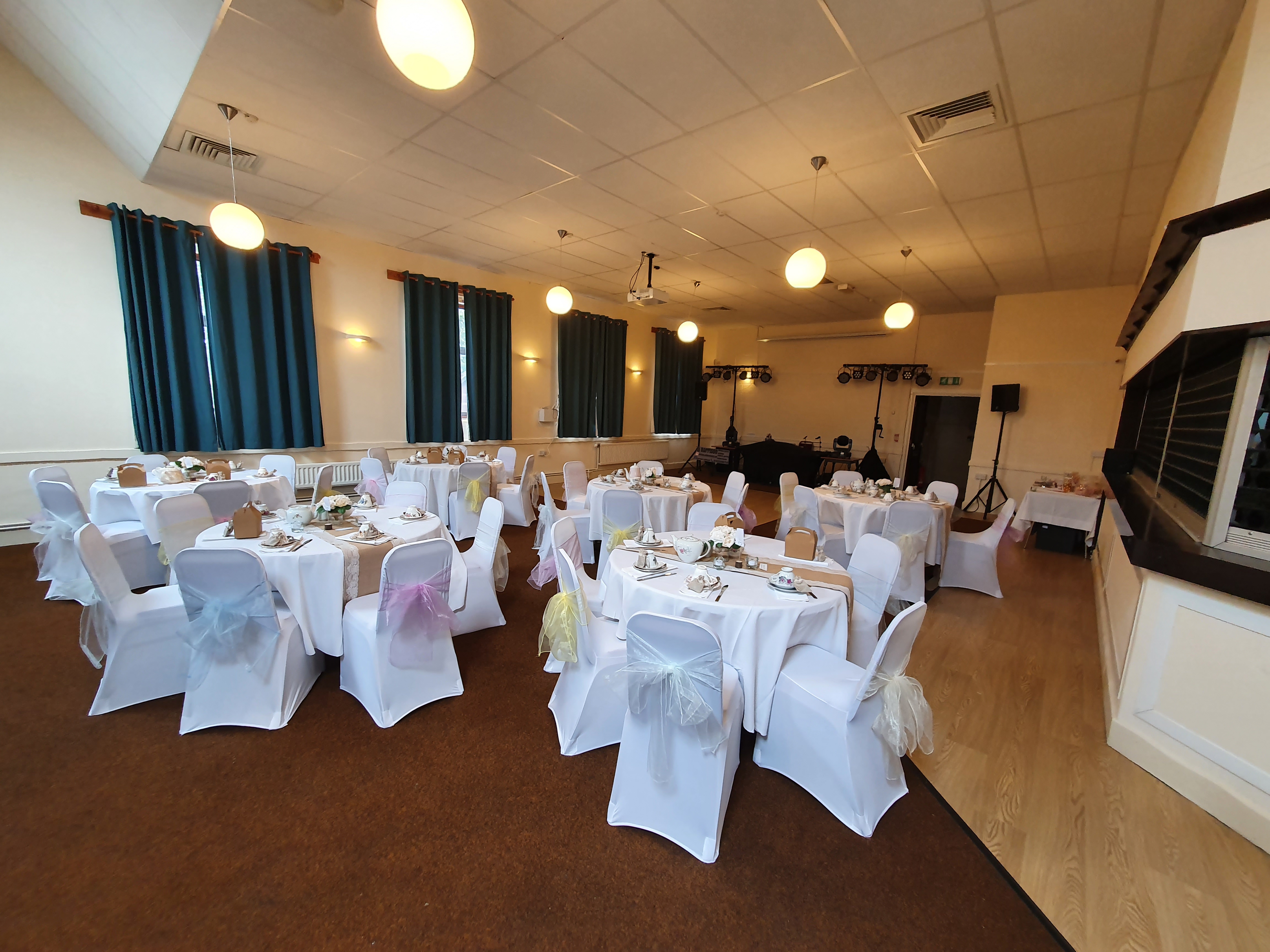 Elegant Woodford Suite event space with round tables, ideal for weddings and corporate events.