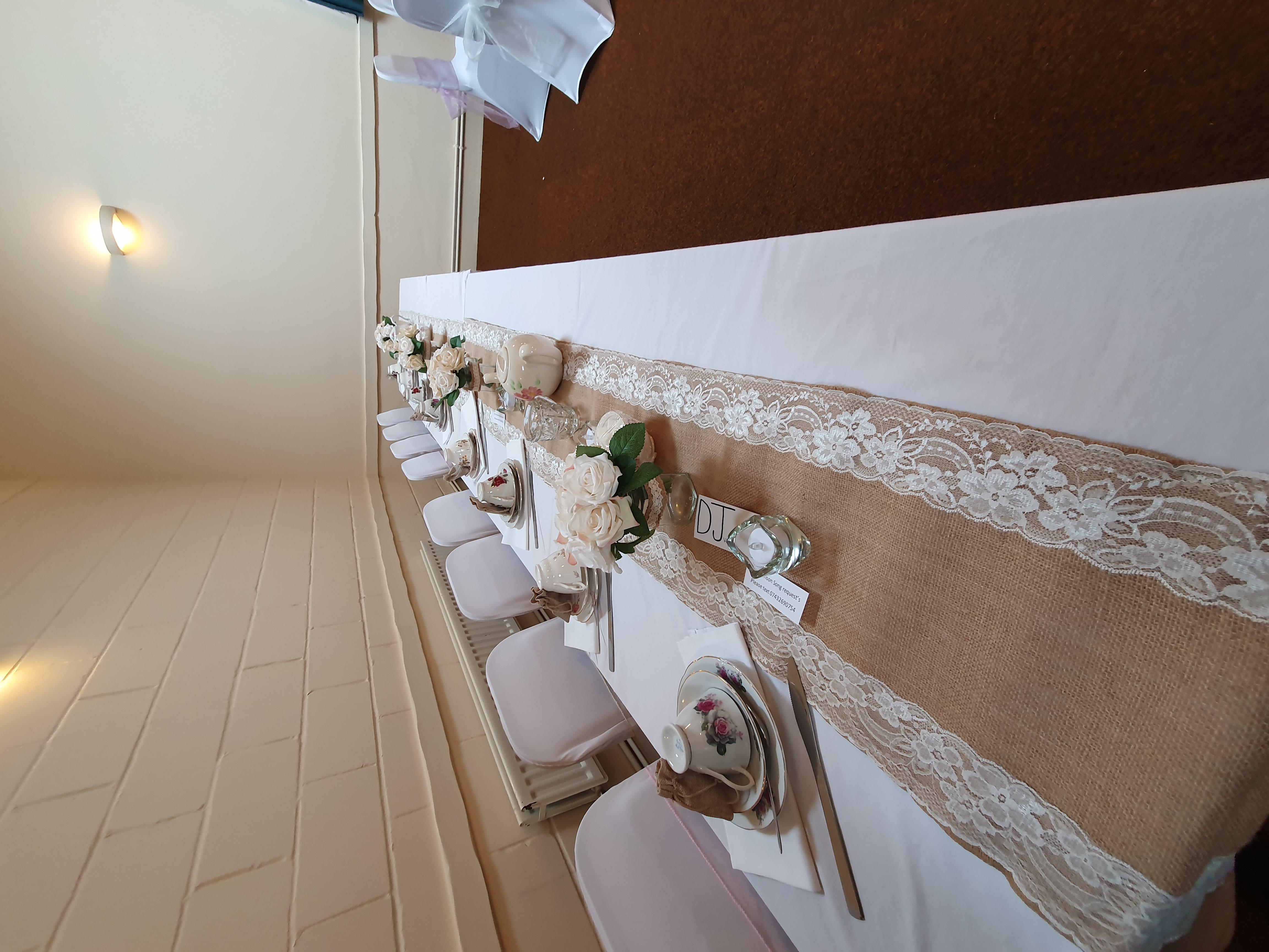 Elegant table setting with floral centerpieces at Wickham Community Centre event.