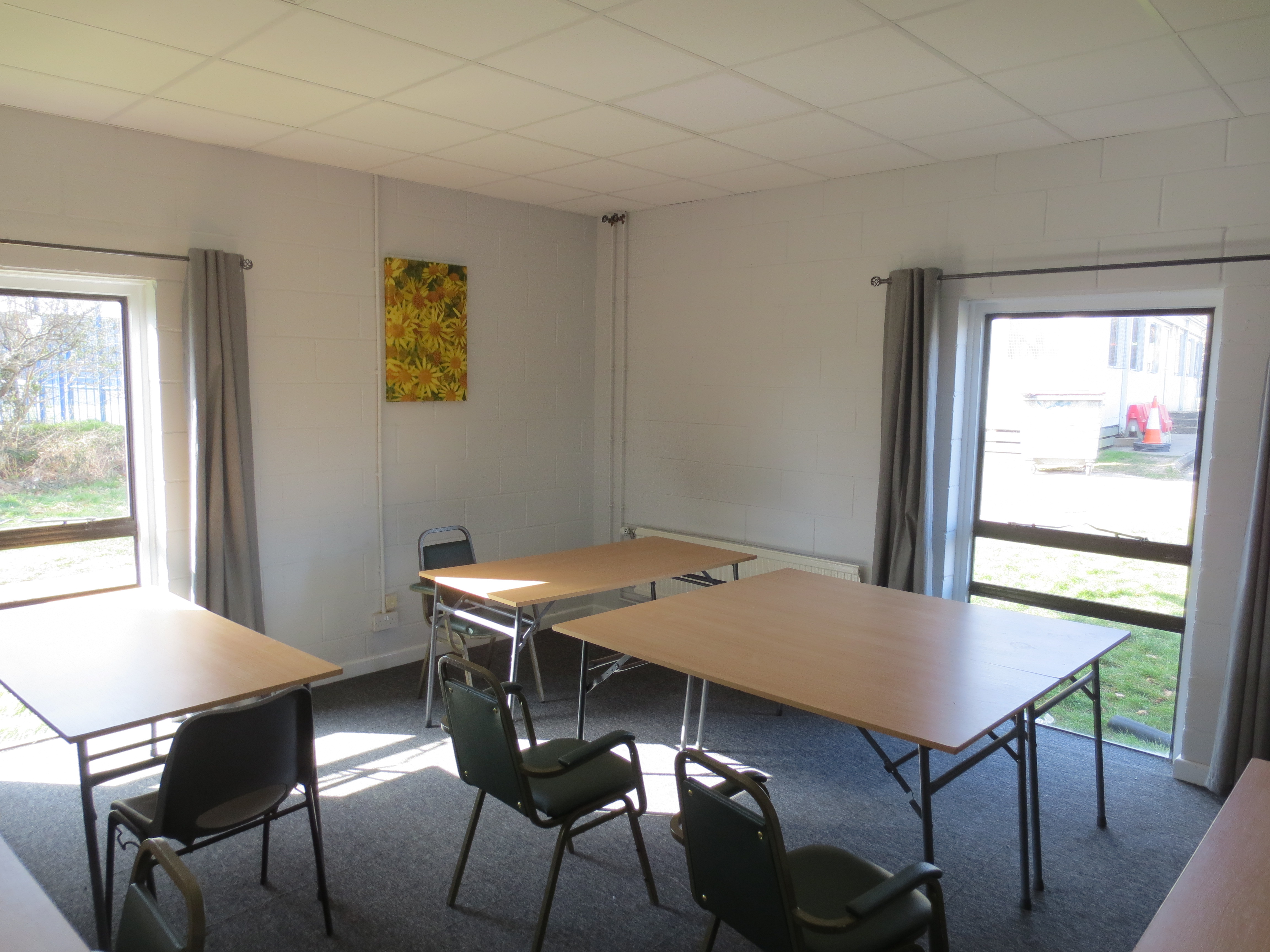 Versatile meeting space with natural light at Wickham Community Centre for workshops and training.