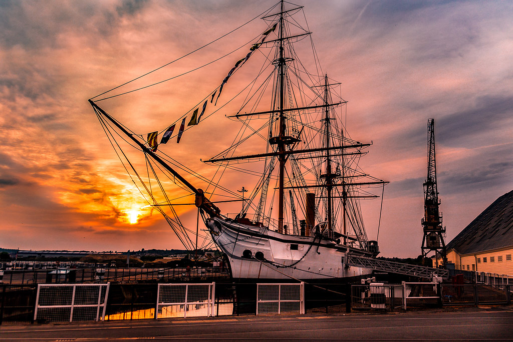 Tall ship at sunset in The Commissioner's House & Gardens, ideal for events and weddings.