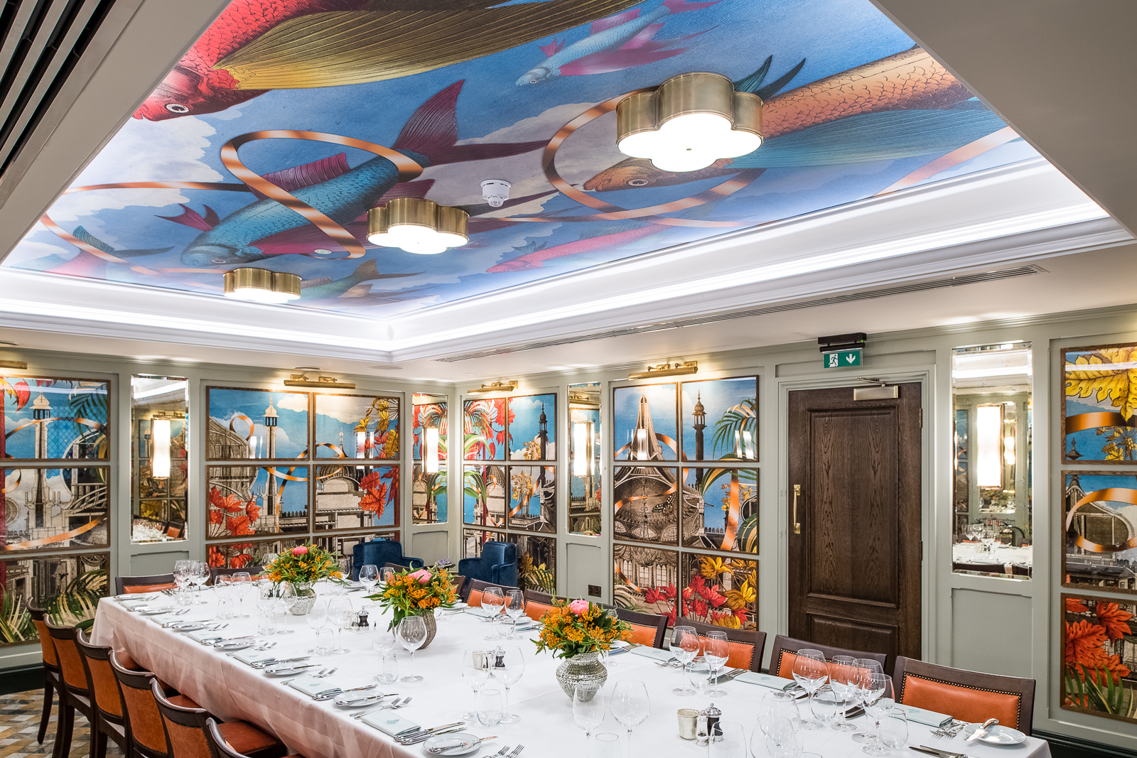 Elegant dining space in The Ivy, Brighton with vibrant mural for events and gatherings.
