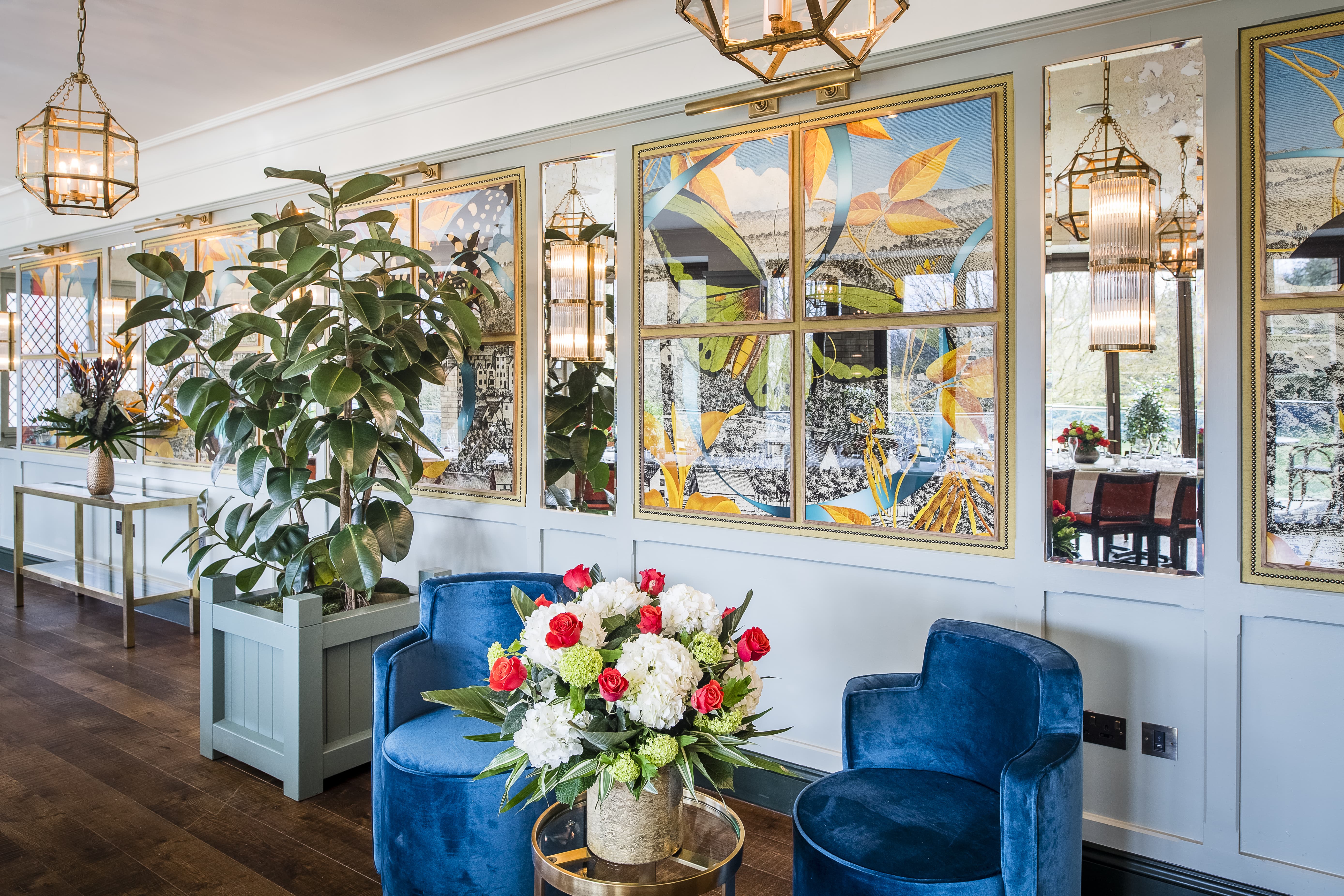 Elegant event space with plush blue chairs and floral decor in Guildford.