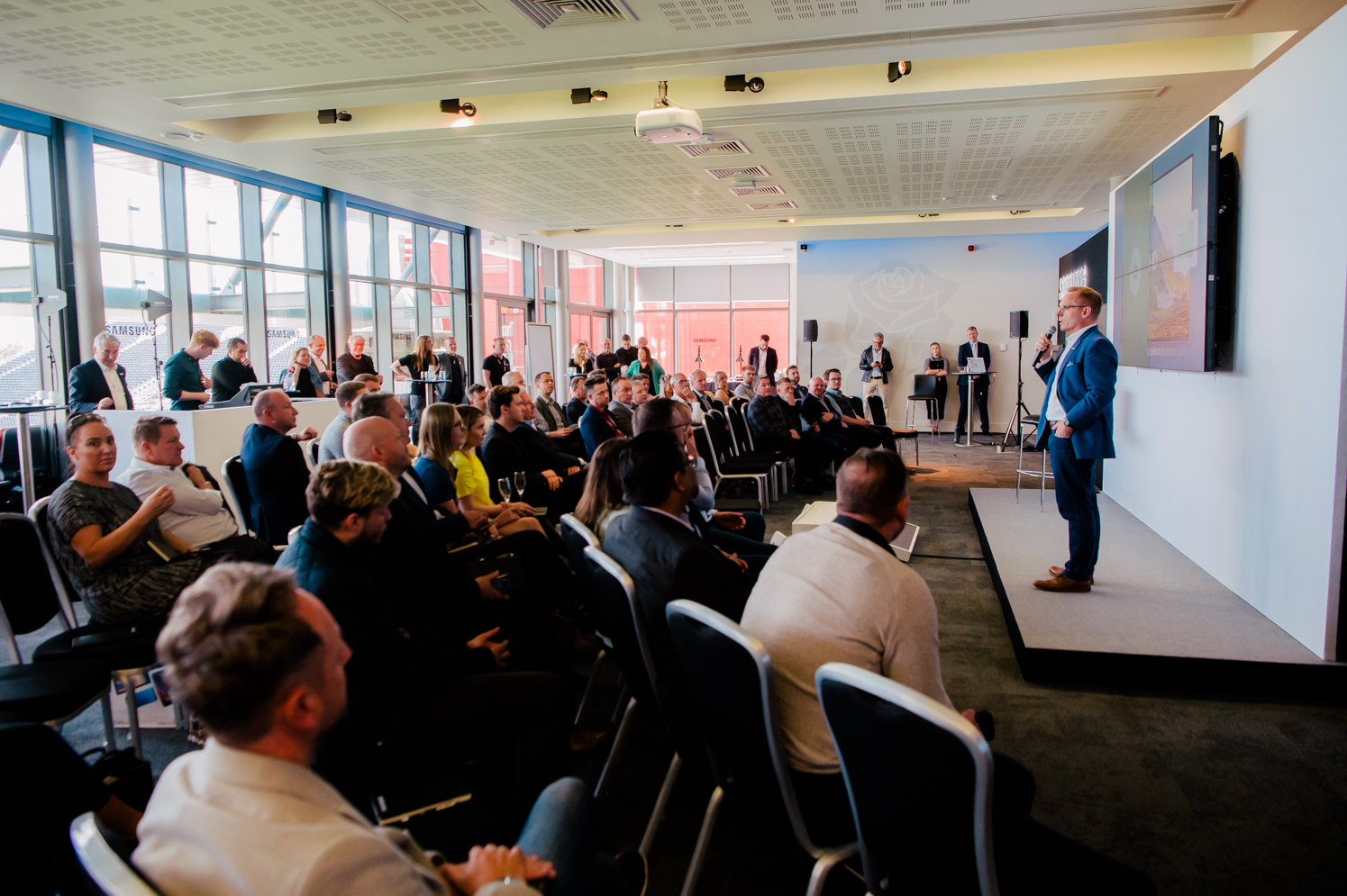 1864 Suite conference at Emirates Old Trafford with natural light and engaged audience.