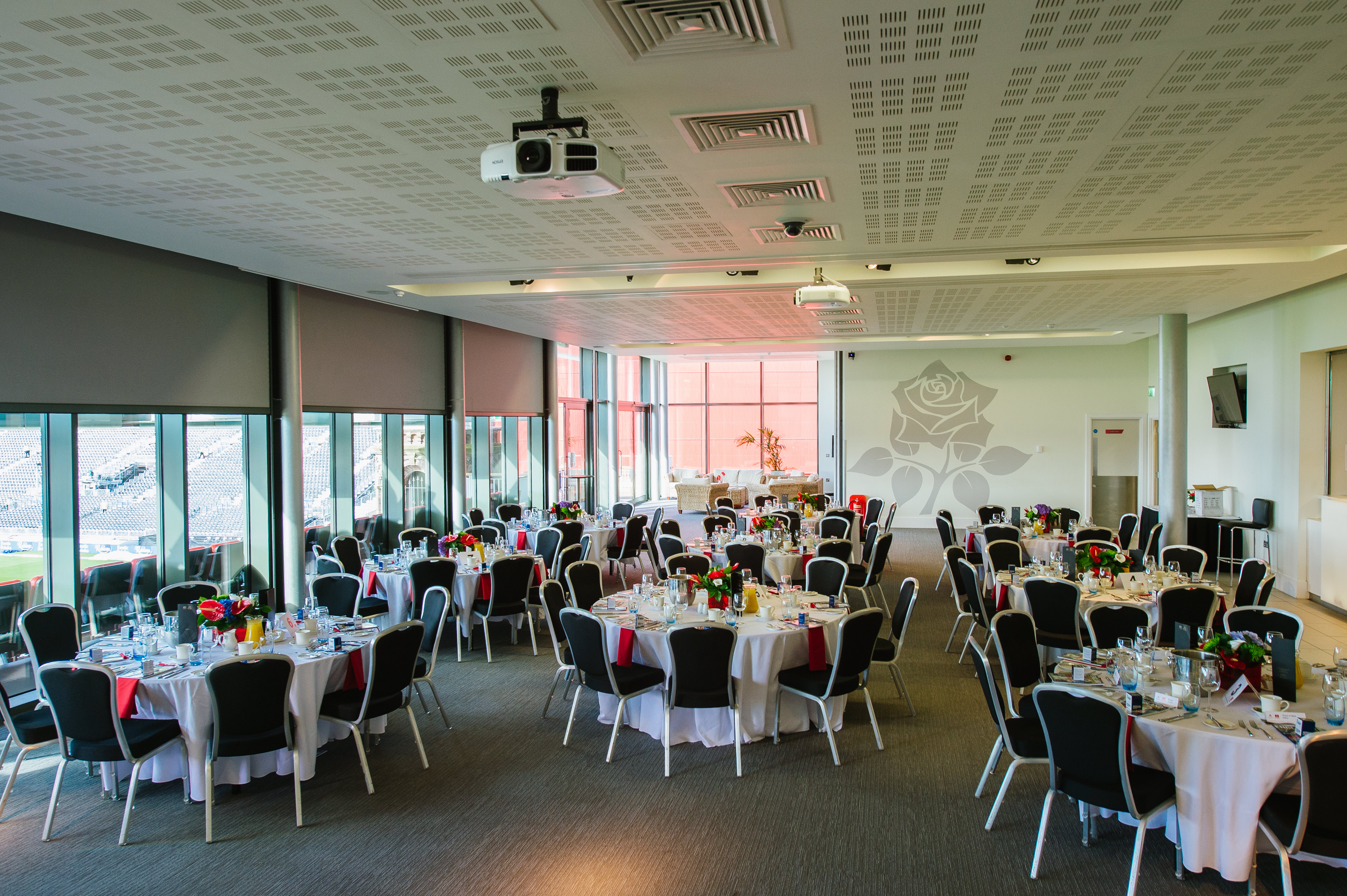 1864 Suite at Emirates Old Trafford, elegant dinner setup for corporate events.