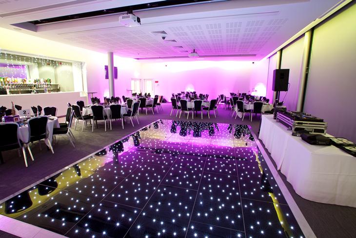 Elegant 1864 Suite at Emirates Old Trafford, featuring a stunning dance floor for events.