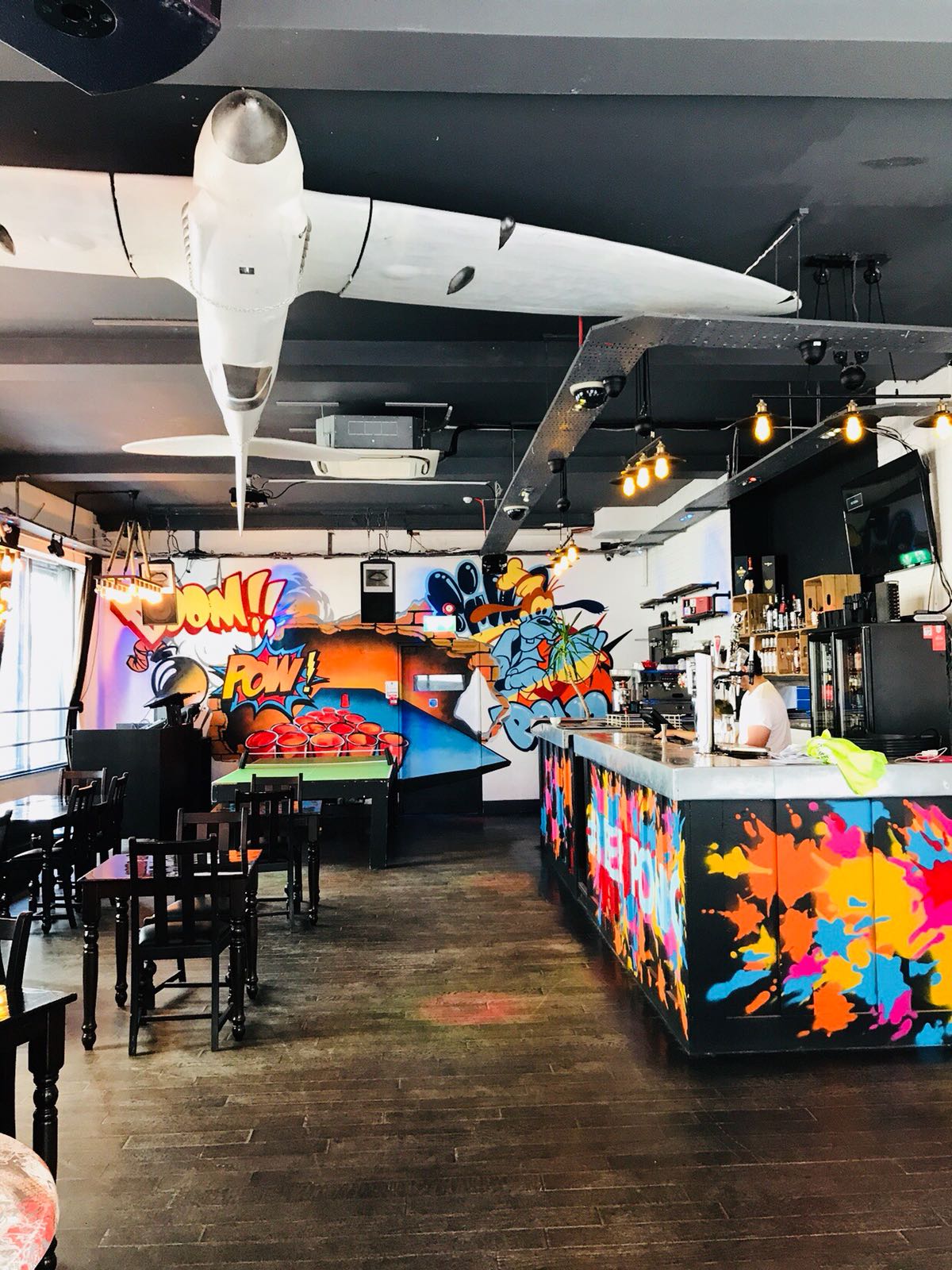 Vibrant Main Bar in Shoreditch with colorful graffiti, ideal for networking events.