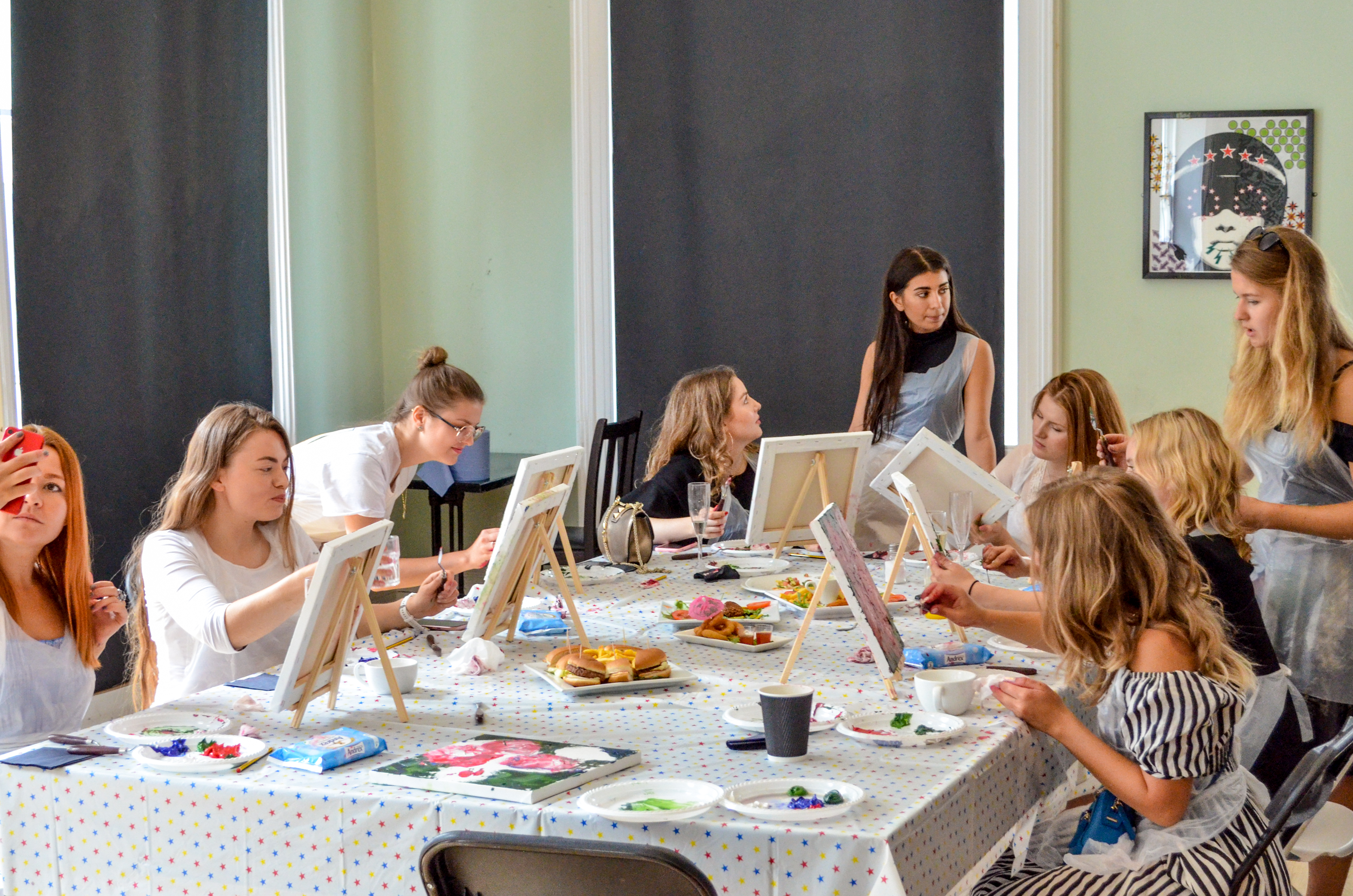Creative team-building event in Sink Pong Shoreditch with painting activity and easels.