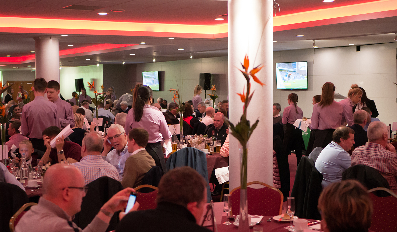 Gorgie Suite at Tynecastle Park, elegant floral centerpieces, vibrant networking event.