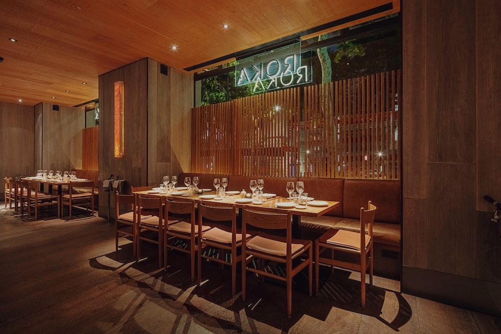 Stylish ROKA Aldwych lounge with warm wood tones, ideal for corporate dinners and gatherings.