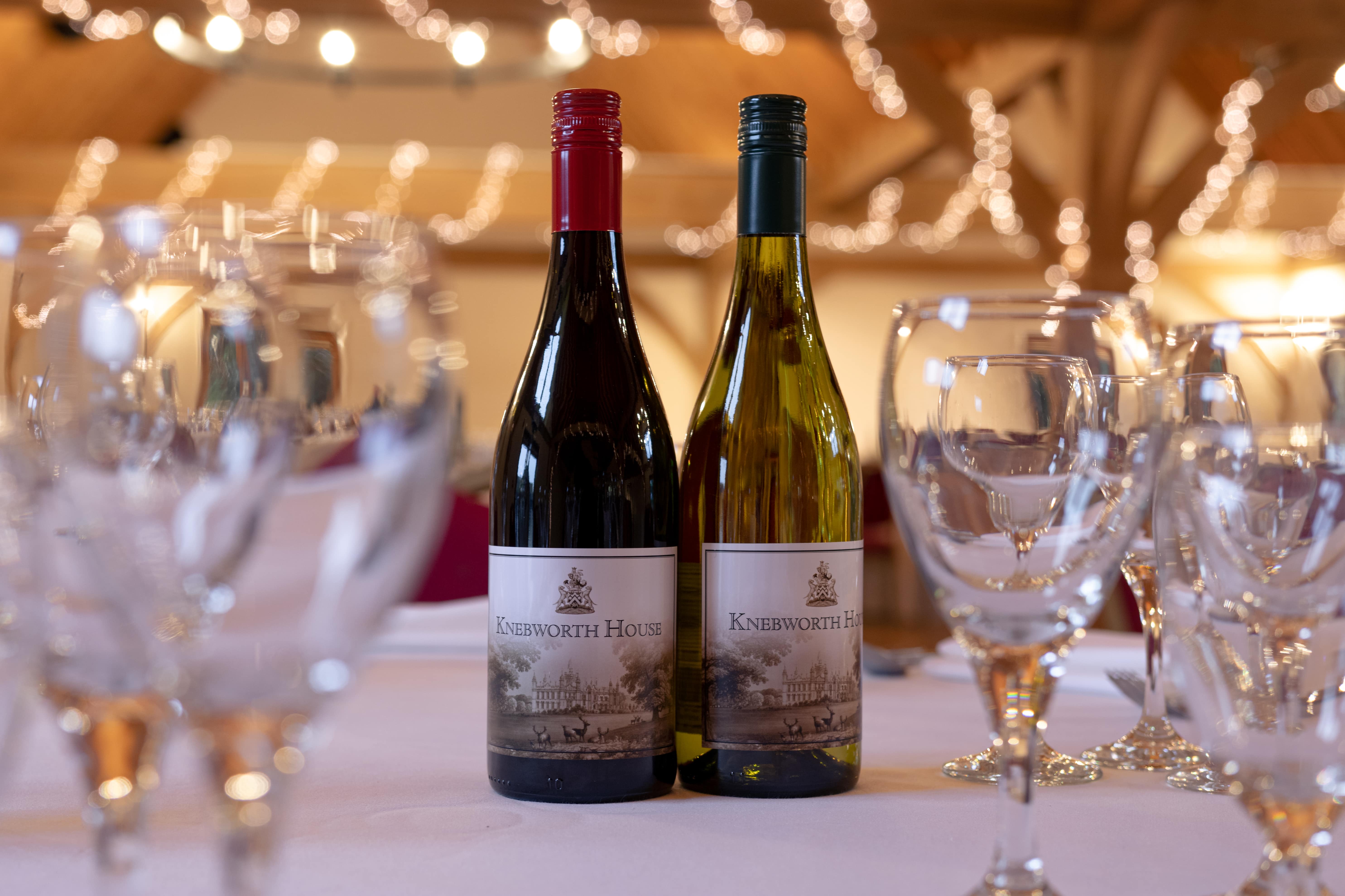 Cobbold Barn table with red and white wine, perfect for elegant networking events.