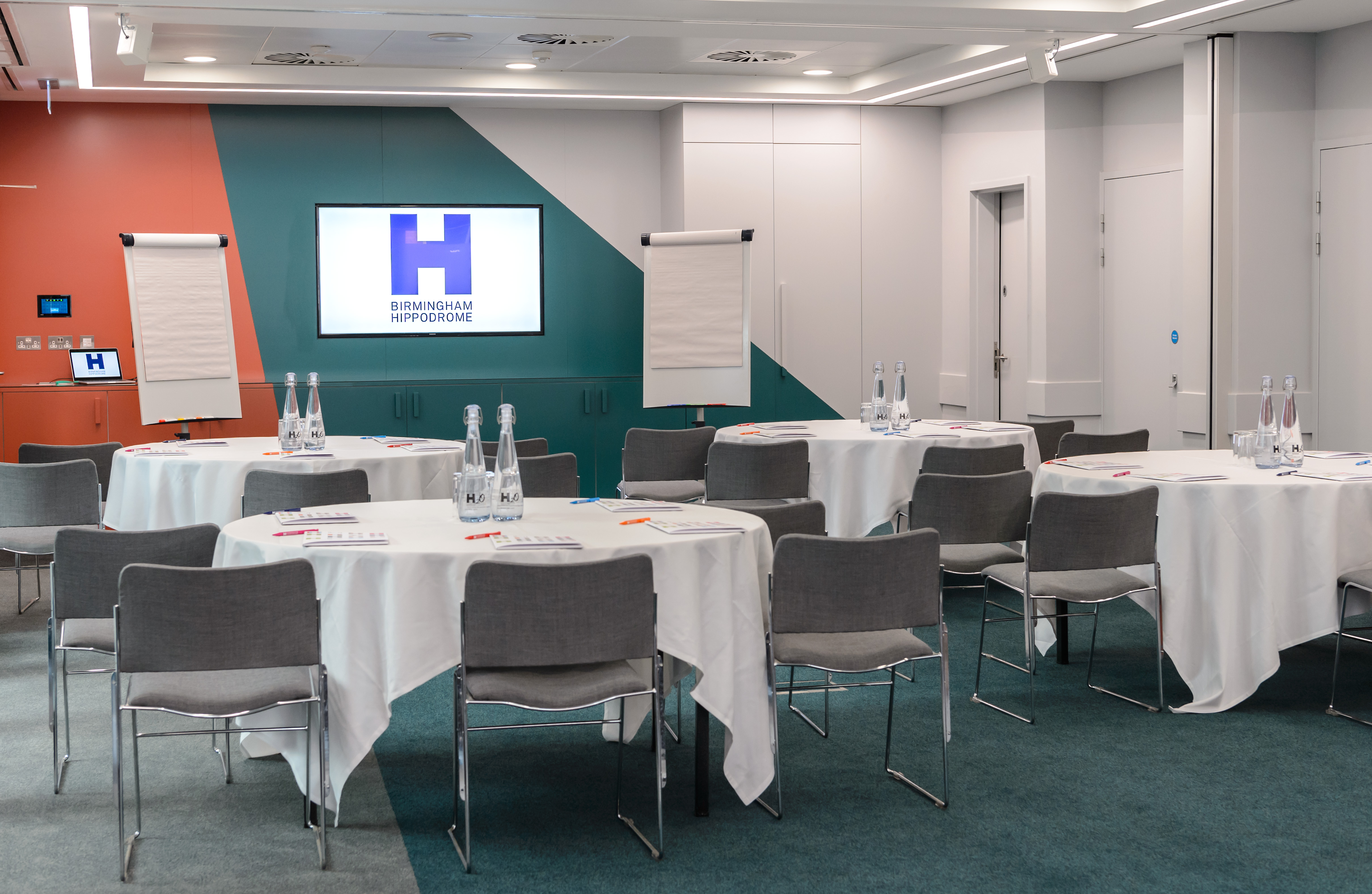 PwC Suite in Birmingham Hippodrome, ideal for workshops with round tables and presentation screen.