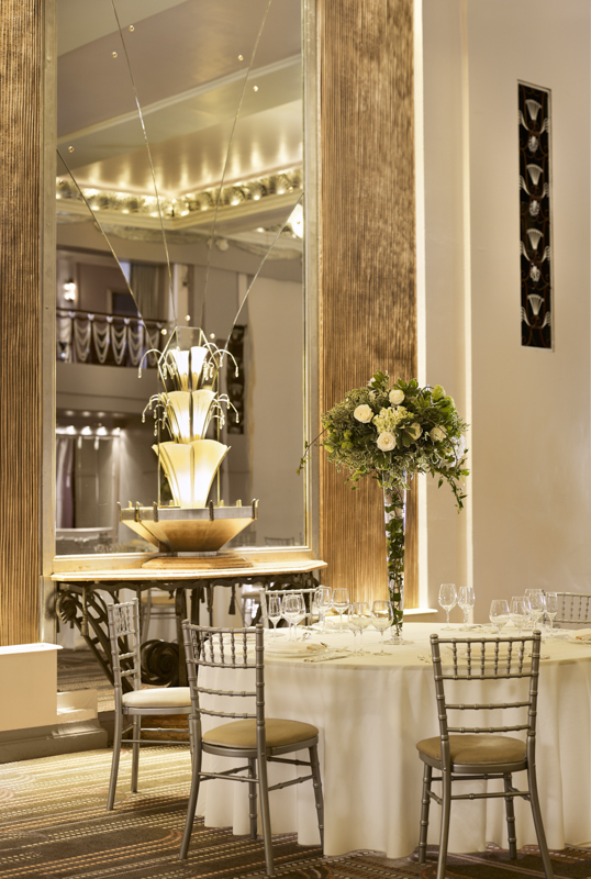 Elegant ballroom at Sheraton Grand London with floral arrangement, ideal for weddings and corporate events.