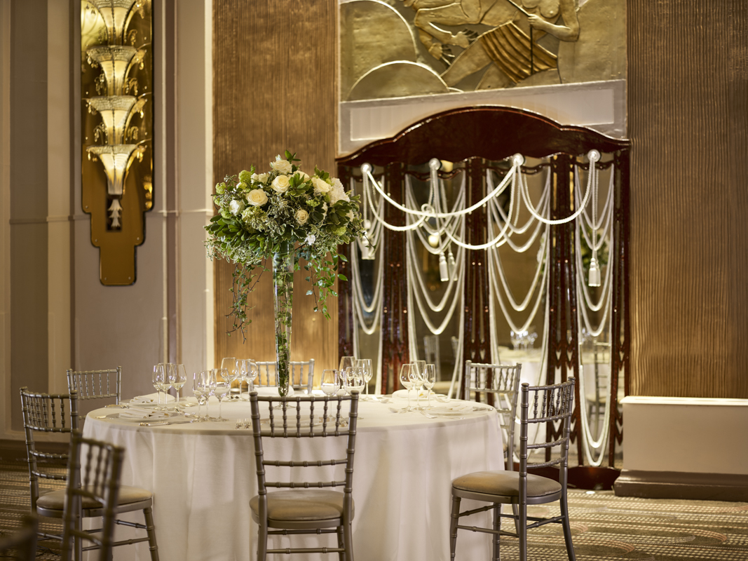 Elegant ballroom table with floral centerpiece for weddings and corporate galas.
