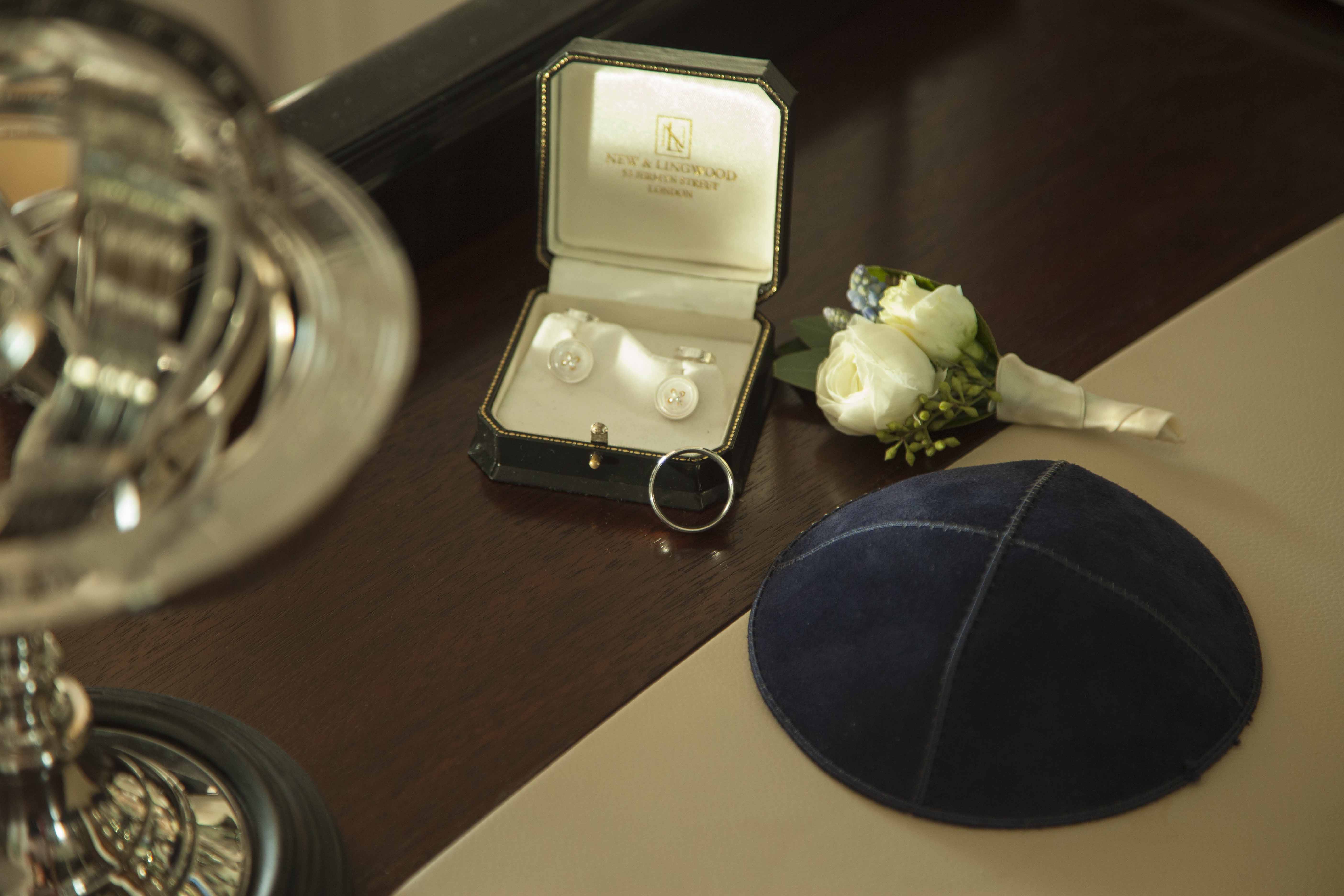 Elegant ballroom setup with cufflinks and boutonnière for weddings or formal events.