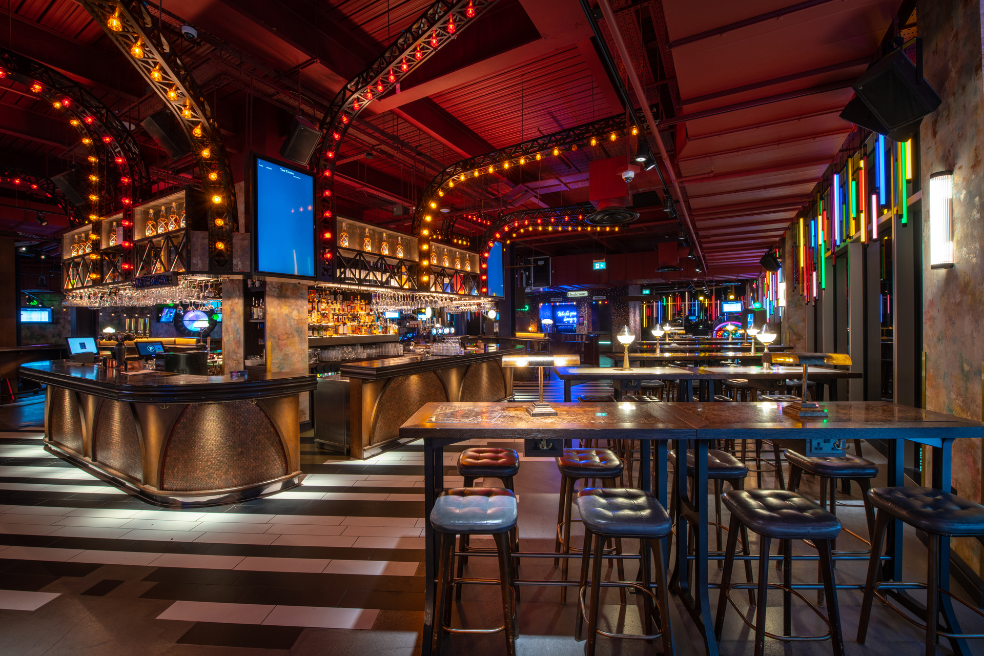 Vibrant event space at Puttshack White City with stylish bar for networking events.