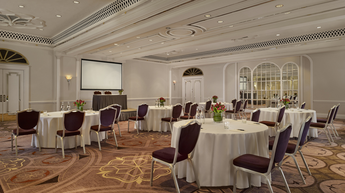 Elegant Tudor Rose event space with floral centerpieces for corporate meetings and gatherings.