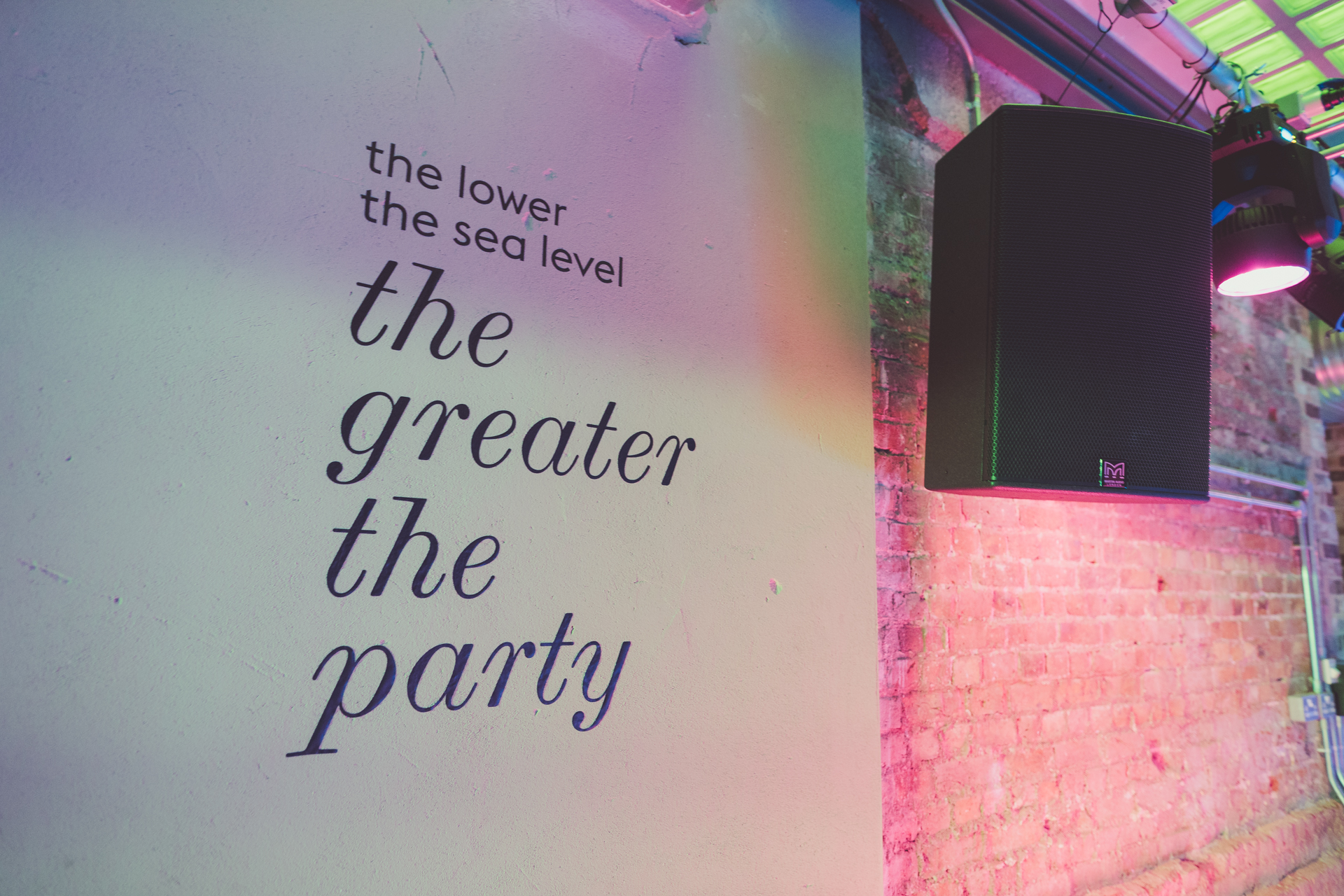 Vibrant event space at The Lower Deck with colorful mural for lively gatherings.