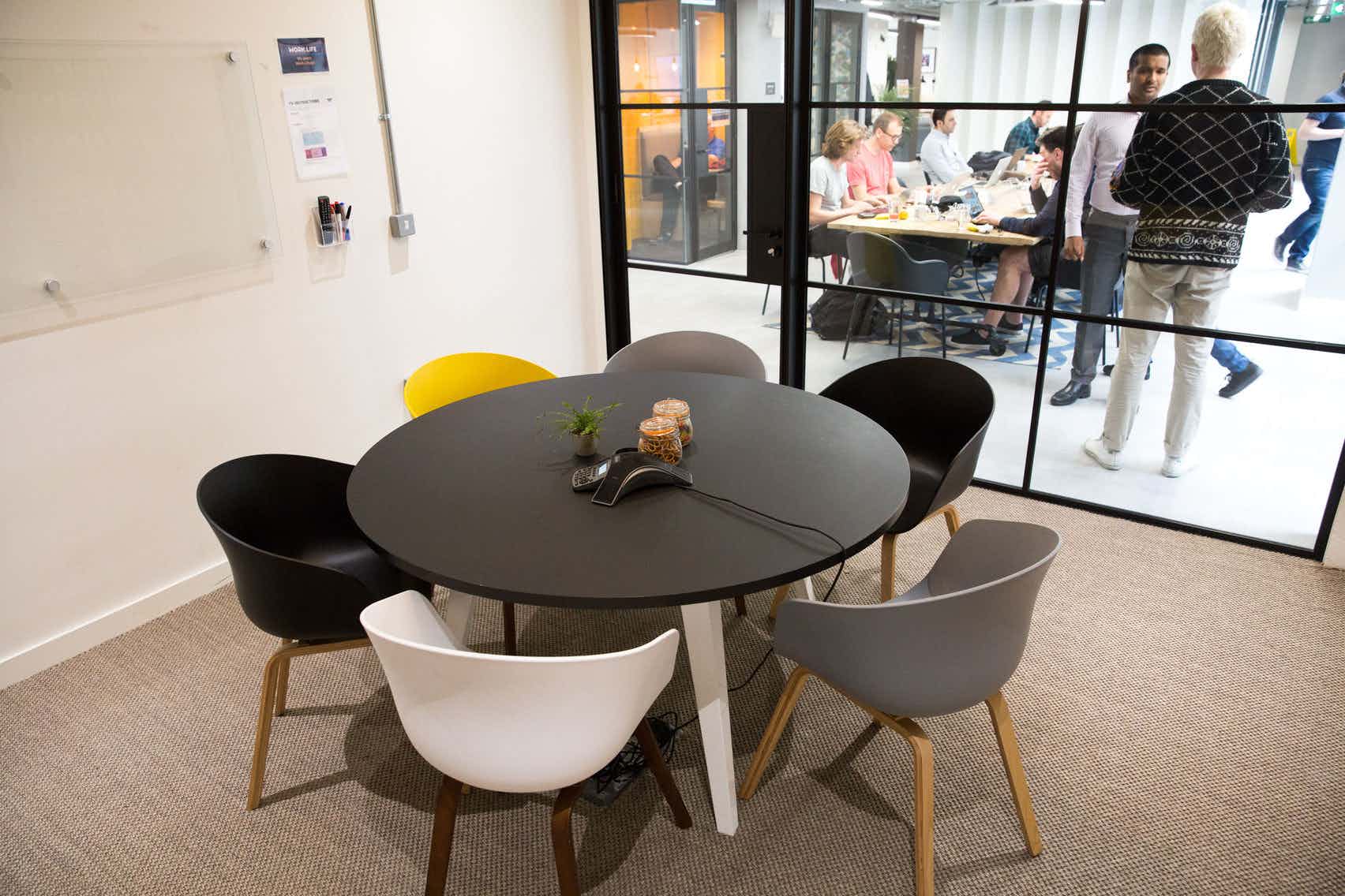 Modern meeting space at The Shard with colorful chairs for collaboration and brainstorming.